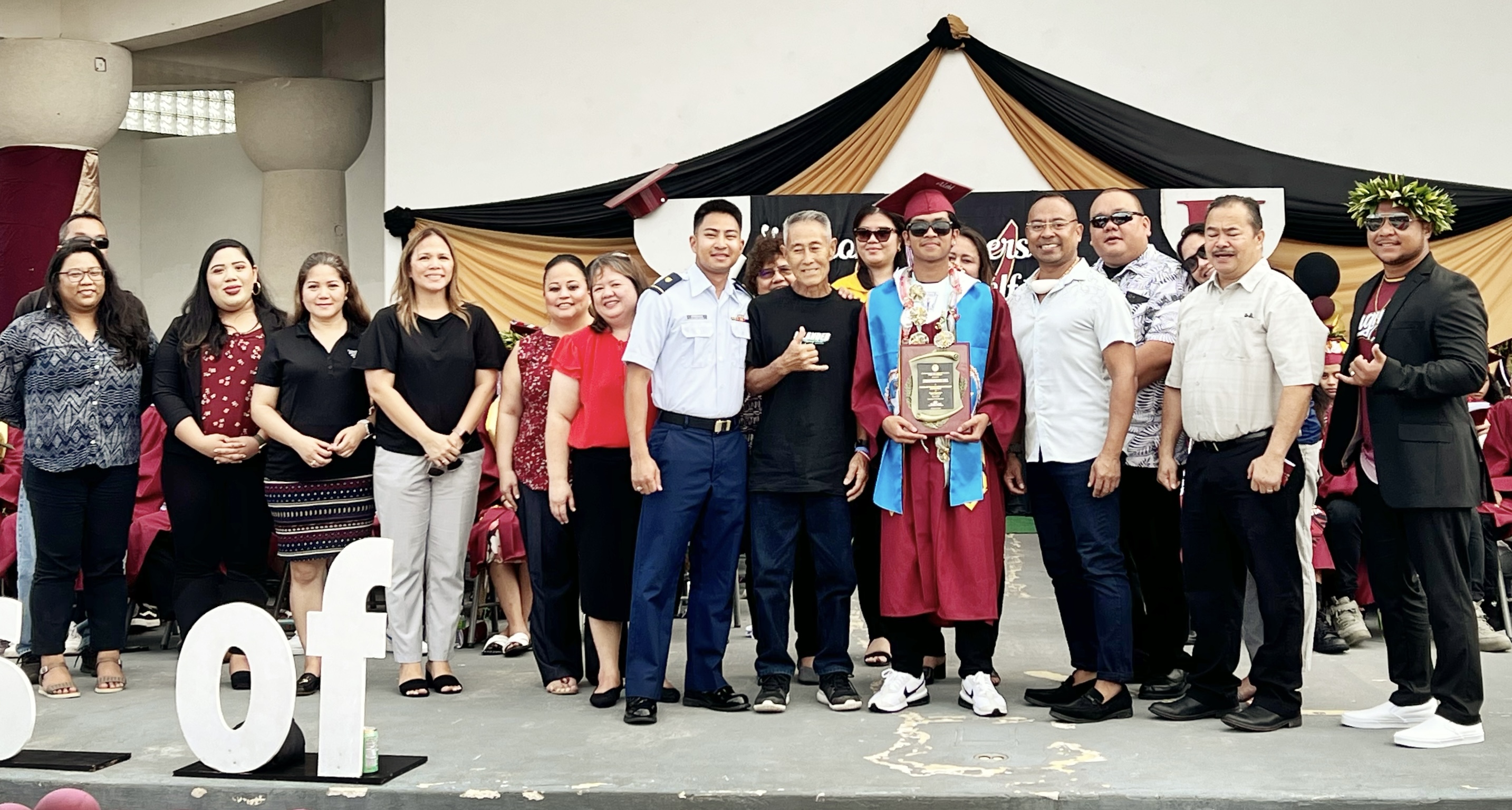 Class salutatorian and the recipient of the Commissioner of Education Academic Excellence Award, Kiyokazu Ma'gas Suzuki Gonzales, with his family. Commissioner of Education Dr. Alfred B. Ada and Associate Commissioner for Administrative Services Eric Magofna led the Public School System leadership team in presenting both awards.