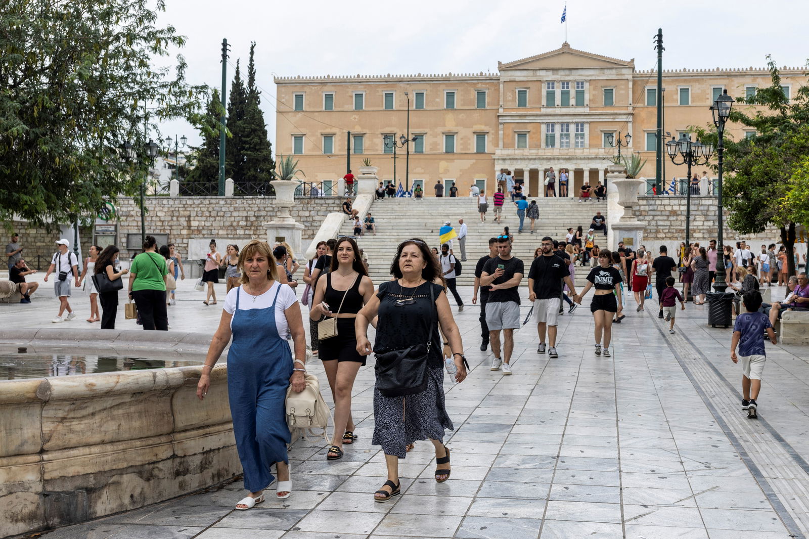 People make their way on Syntagma square, moments after the announcement of the first exit polls, following a general election, in Athens, Greece, June 25, 2023. REUTERS/Alkis Konstantinidis