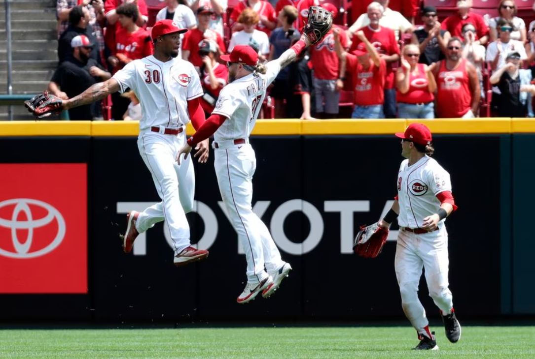 Cincinnati Reds left fielder Will Benson (30) right fielder Jake Fraley (27) and center fielder TJ Friedl (29) celebrate after the Reds defeated the Colorado Rockies at Great American Ball Park in Cincinnati, Ohio, June 21, 2023.