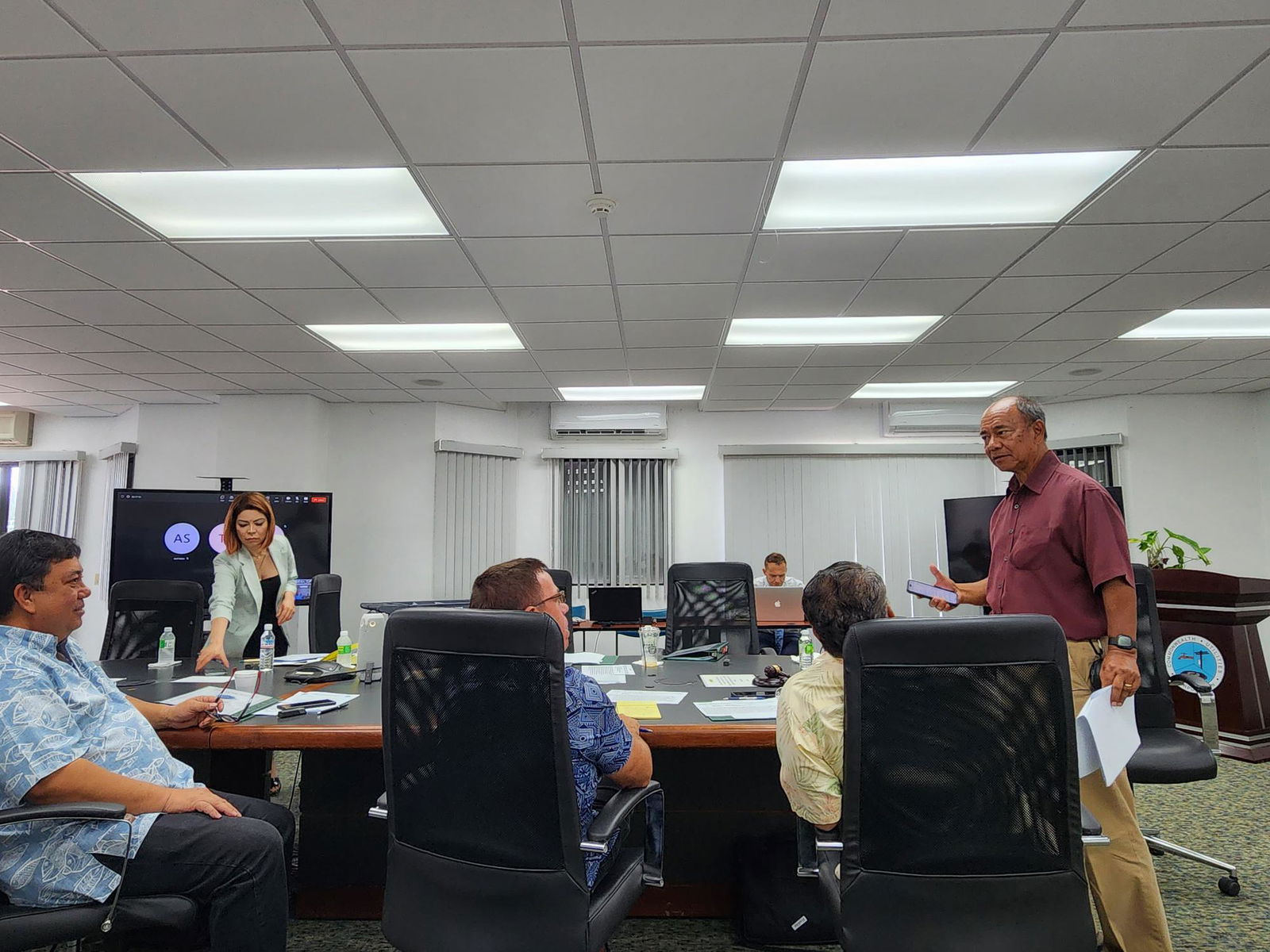 Simon Sanchez, standing right, speaks with the other Commonwealth Utilities Corp. board members during a meeting Friday. Seated, from left, Rufino Mafnas, Donald Browne, and Allen Perez.