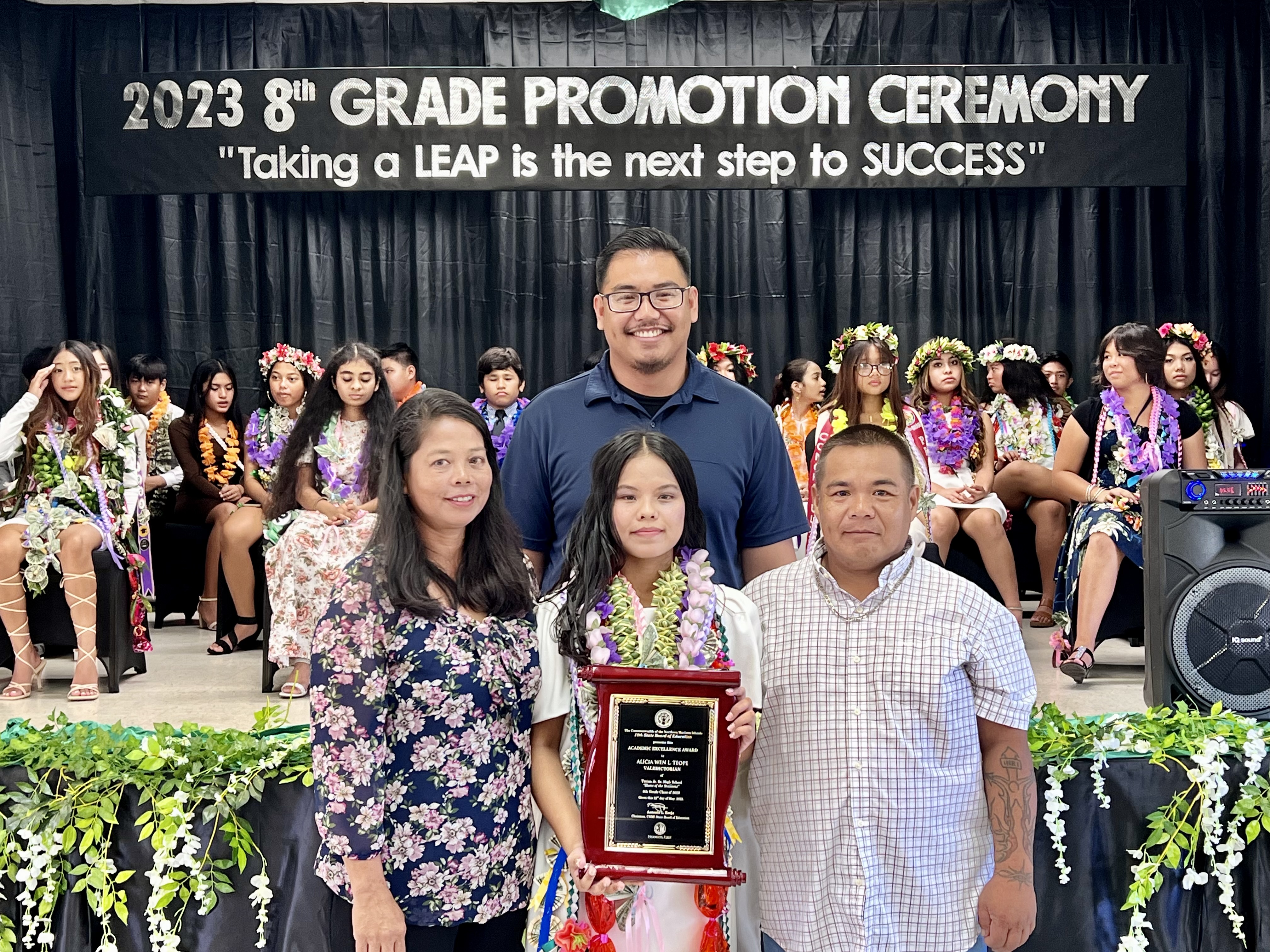 Class valedictorian Alecia Wen L. Teope with her proud parents and Board of Education Chairman Antonio L. Borja.