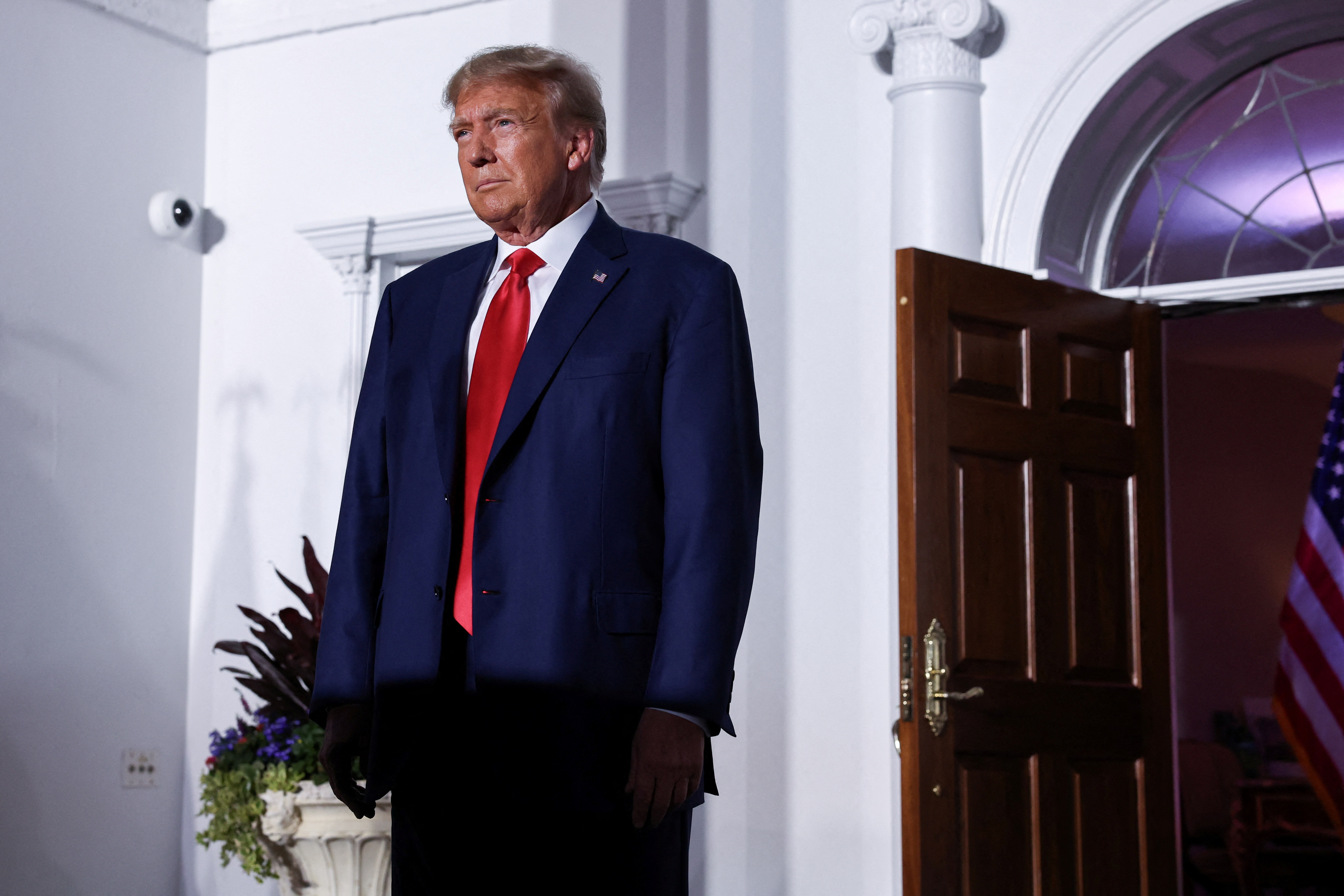 FILE PHOTO: Former U.S. President Donald Trump reacts on stage following his arraignment on classified document charges, at Trump National Golf Club, in Bedminster, New Jersey, U.S., June 13, 2023. REUTERS/Amr Alfiky/File Photo