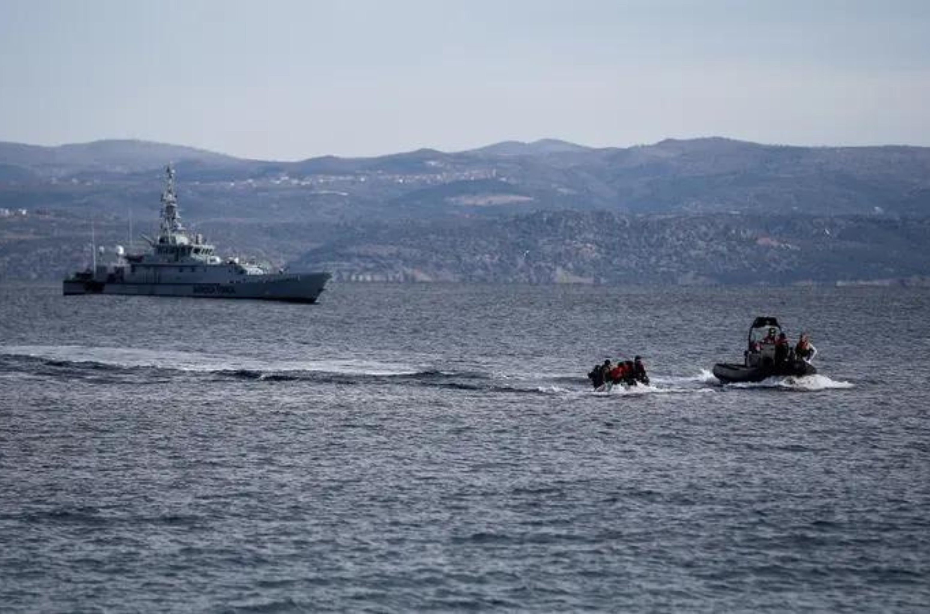 A rescue boat escorts a dinghy with migrants from Afghanistan as a Frontex vessel patrols in the background, on the island of Lesbos, Greece, February 28, 2020. (File photo: Reuters) 