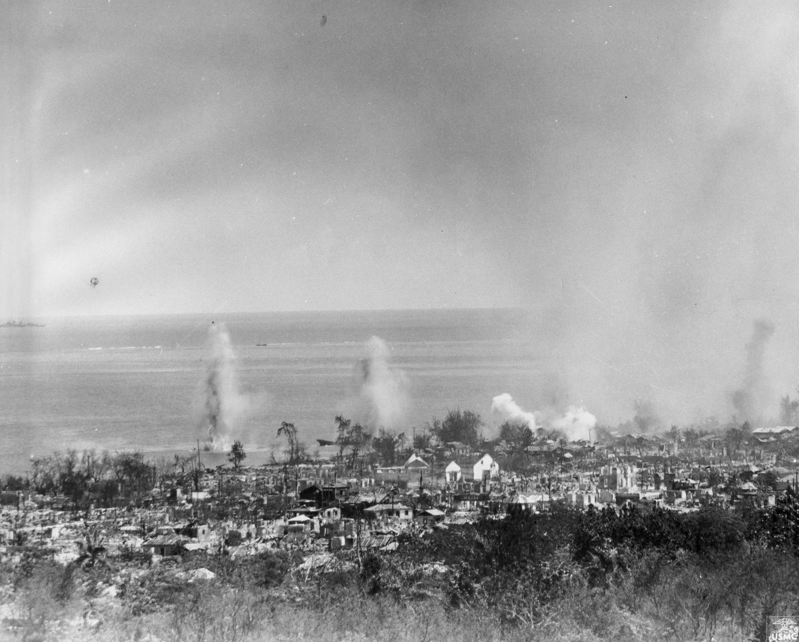 U.S. Marine Corps artillery shells explode in Garapan as the 2nd Marine Division moves north.