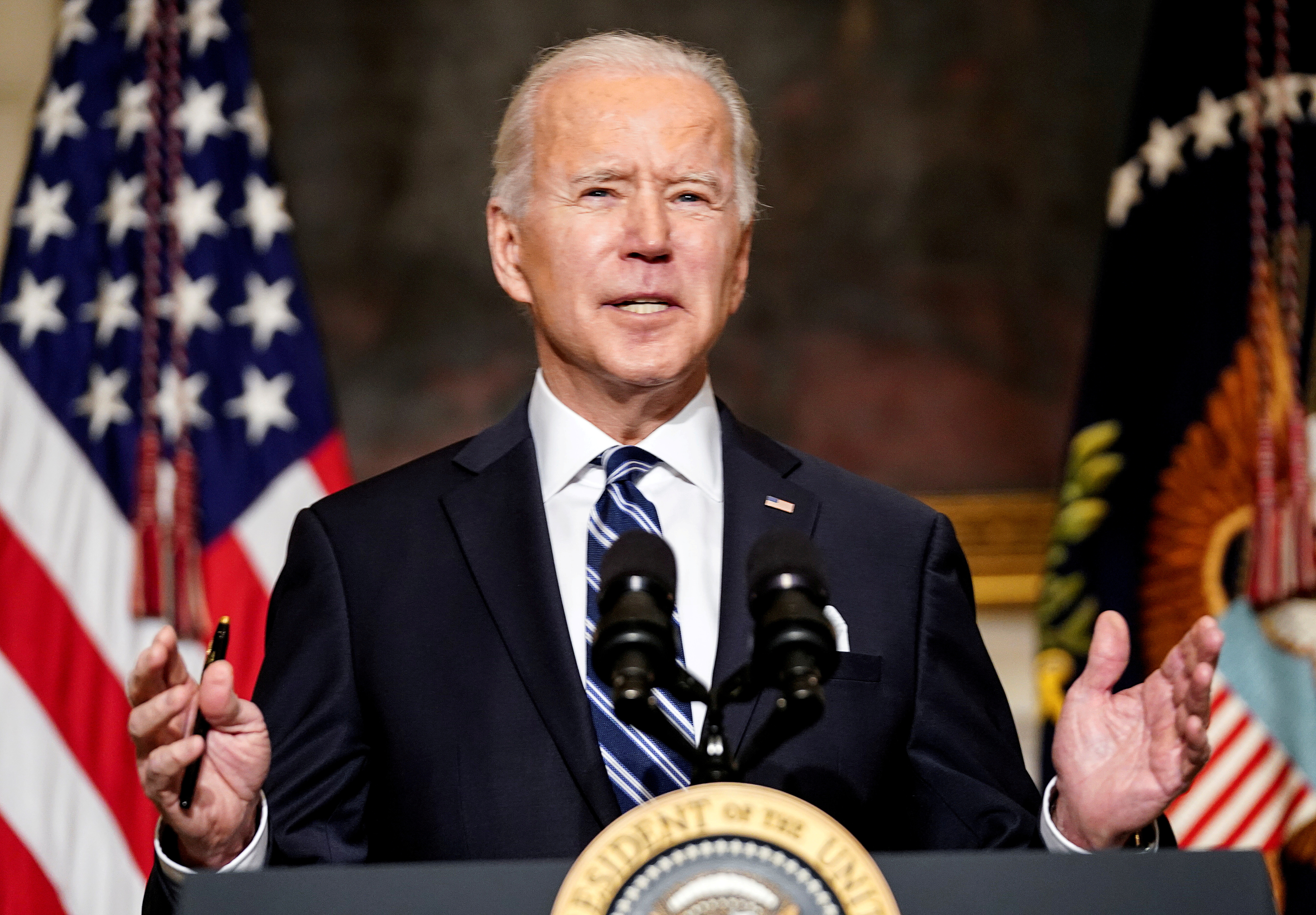 FILE PHOTO: U.S. President Joe Biden delivers remarks on tackling climate change prior to signing executive actions in the State Dining Room at the White House in Washington, U.S., January 27, 2021. REUTERS/Kevin Lamarque/File Photo
