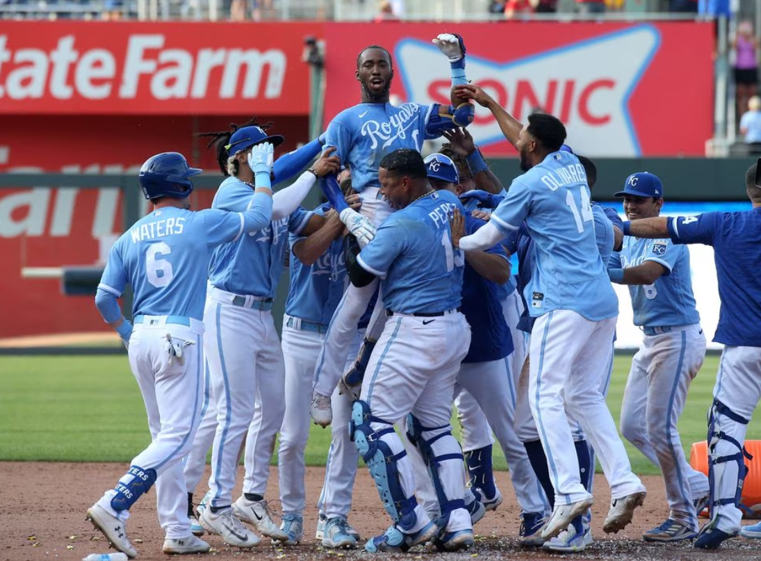 Kansas City Royals left fielder Samad Taylor (0) is lifted in the air by teammate Salvador Perez (13) after Taylor hit the game-winning single in his major league debut against the Los Angeles Angels at Kauffman Stadium in Kansas City, Missouri, June 17, 2023.