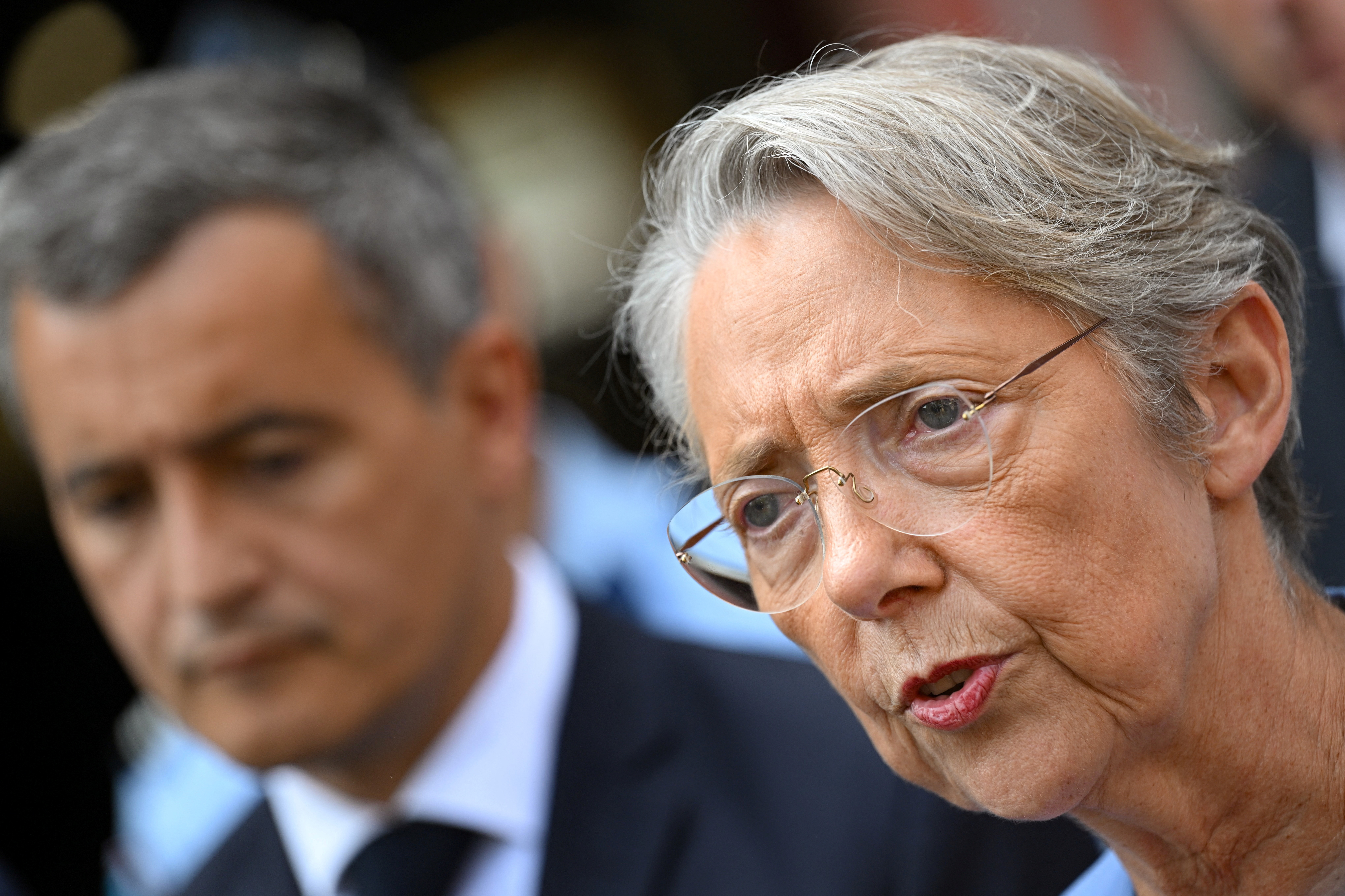 French Prime Minister Elisabeth Borne delivers remarks to journalists, flanked by French Interior and Overseas Minister Gerald Darmanin outside a police station, following riots after a 17-year-old boy was killed by police in Nanterre, a western suburb of Paris, in Evry-Courcouronnes, south of Paris, France, on June 30, 2023. STEFANO RELLANDINI/Pool via REUTERS
