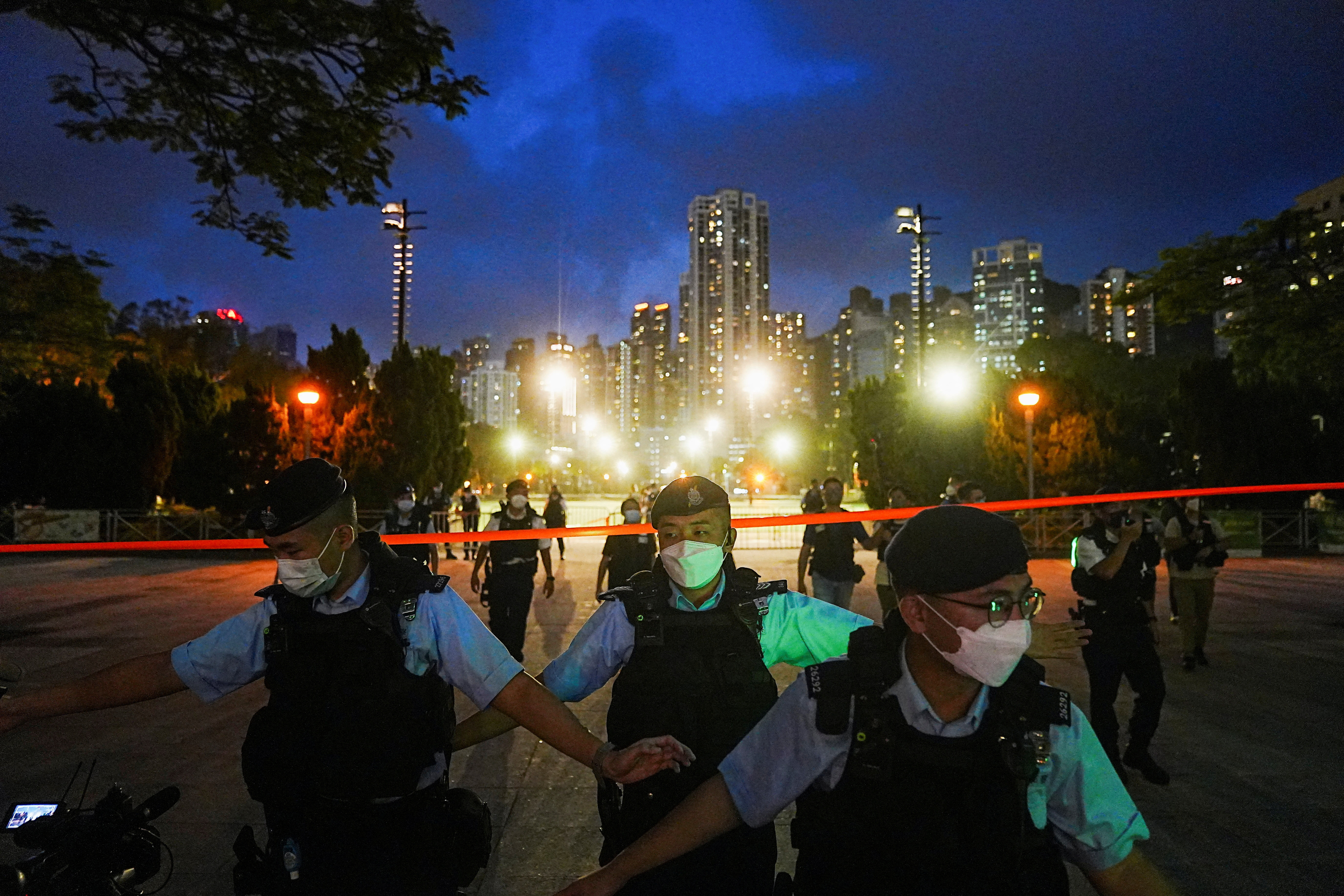 FILE PHOTO: Police officers disperse people at the closed Victoria Park on the 33rd anniversary of the crackdown on pro-democracy demonstrations at Beijing's Tiananmen Square in 1989, in Hong Kong, China, June 4, 2022. REUTERS/Lam Yik