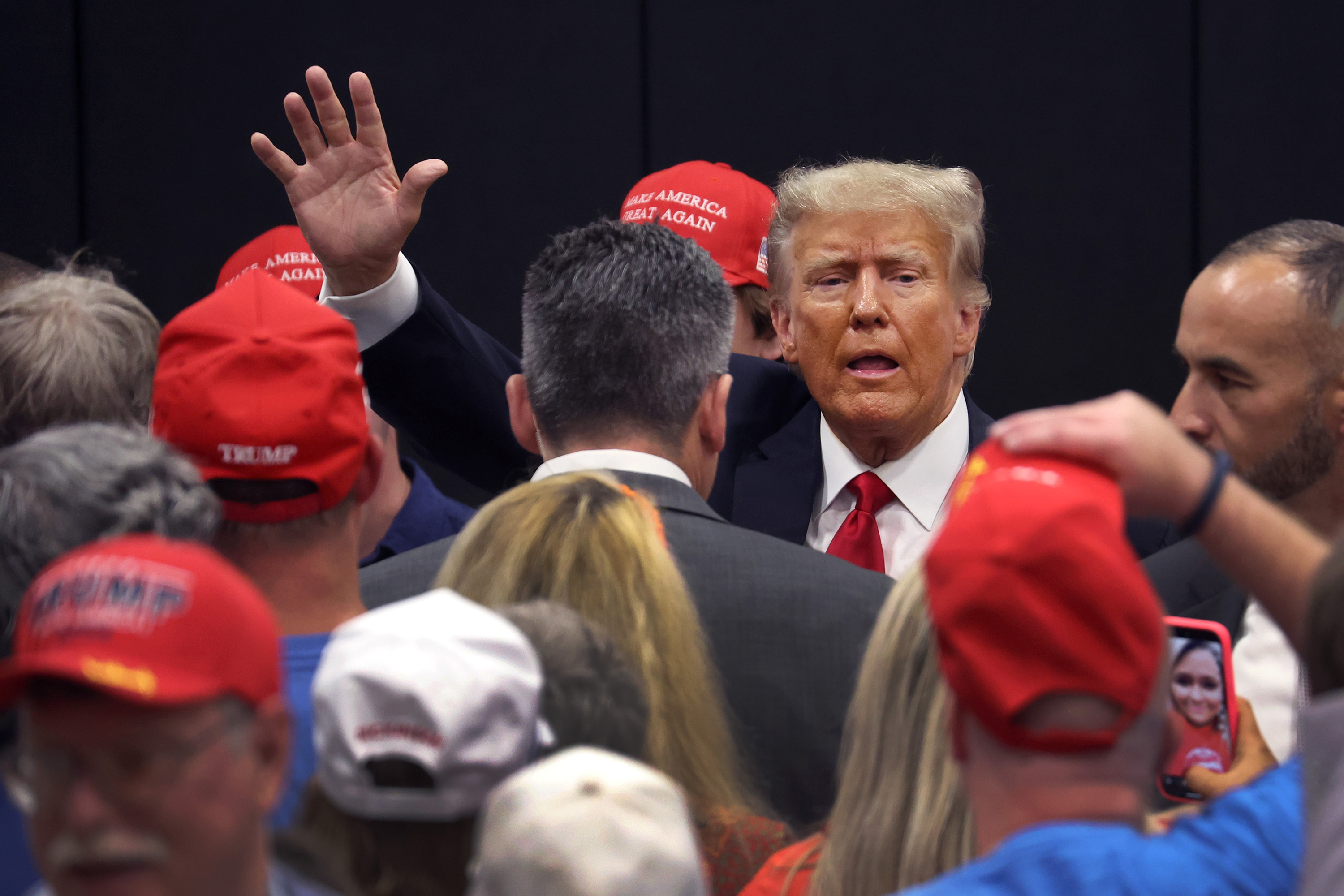 Former President Donald Trump greets supporters at a Team Trump volunteer leadership training event held at the Grimes Community Complex on June 1, 2023, in Grimes, Iowa. (Scott Olson/Getty Images/TNS)