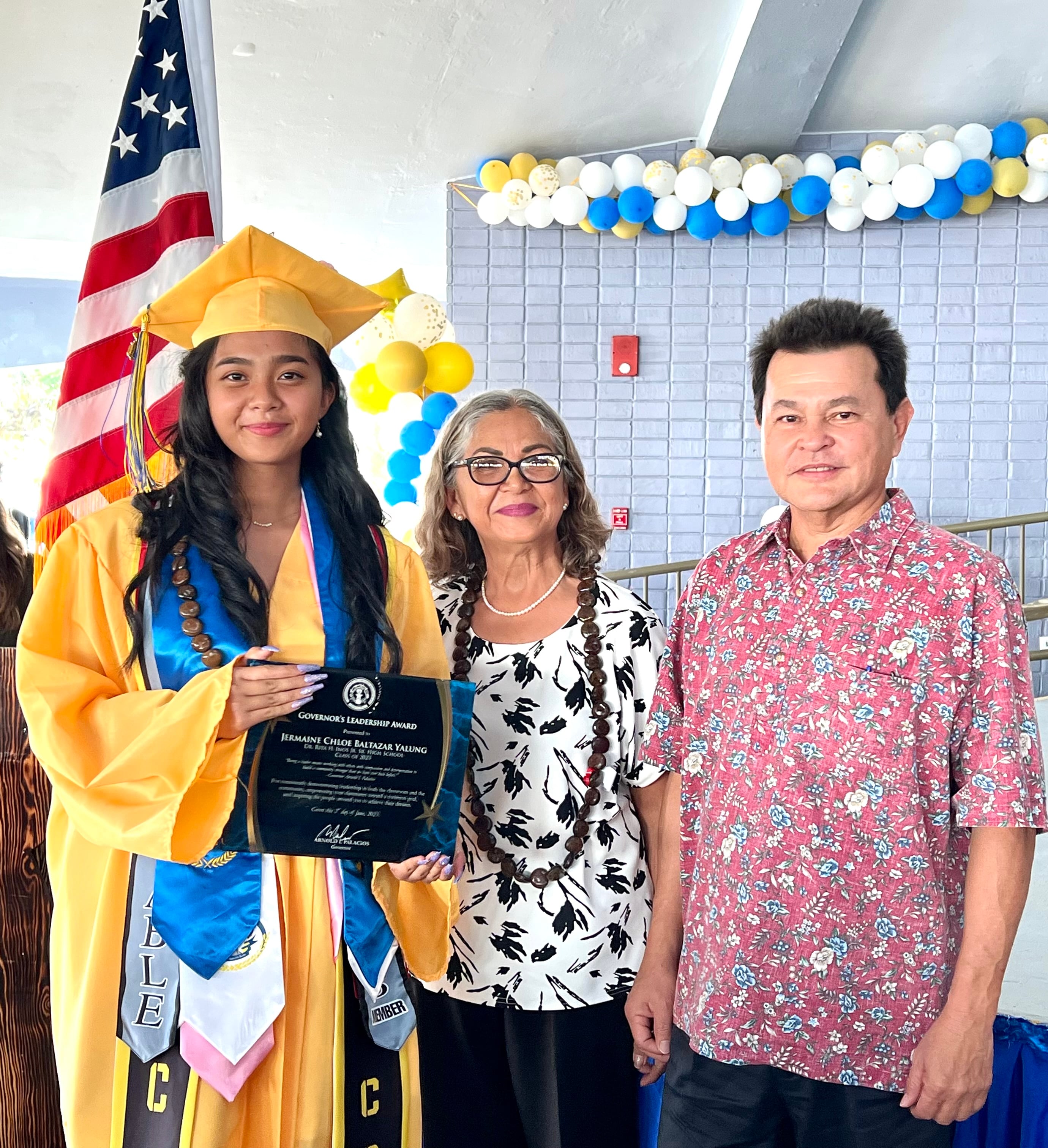 Valedictorian Jermaine Chloe Baltazar Yalung, the recipient of the Governor’s Leadership Award,  poses for a photo with Henry Hofschneider, the chief of staff of Lt. Gov. David M. Apatang, and Barbara Sablan, the governor’s special assistant for women’s affairs.