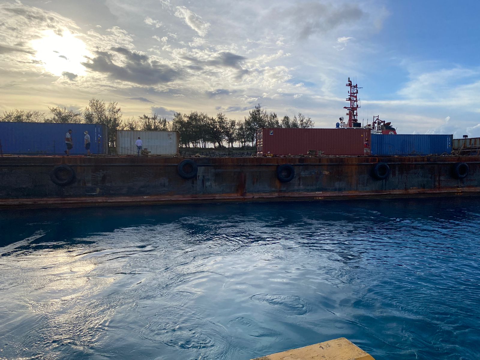 Some of the container vans that were offloaded at West Harbor are photographed by a crewmember of a cargo ship leaving the harbor on Monday. 