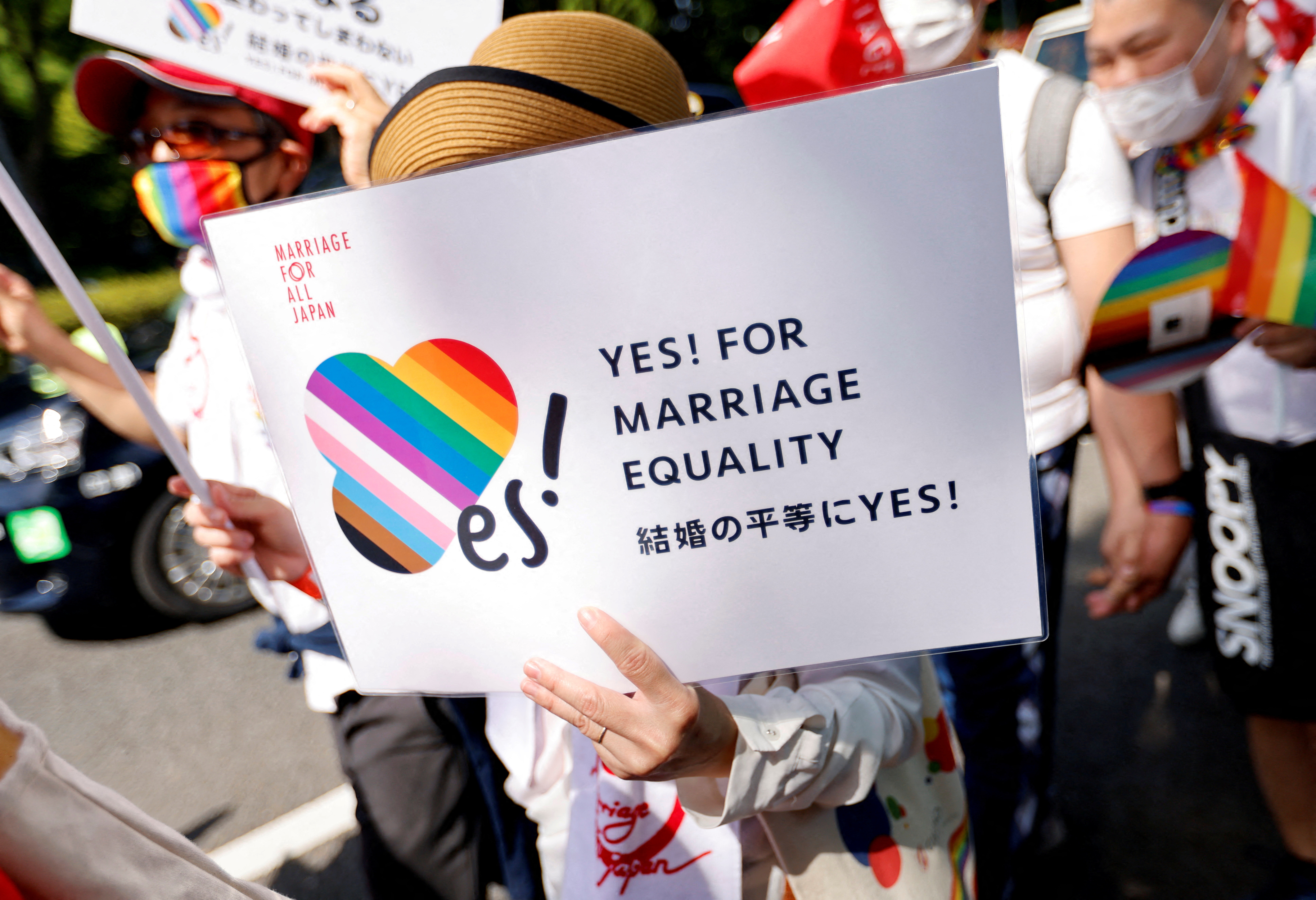 FILE PHOTO: A participant holds a sign as they march during the Tokyo Rainbow Pride parade, celebrating advances in LGBTQ rights and calling for marriage equality, in Tokyo, Japan April 23, 2023. REUTERS/Issei Kato/File Photo