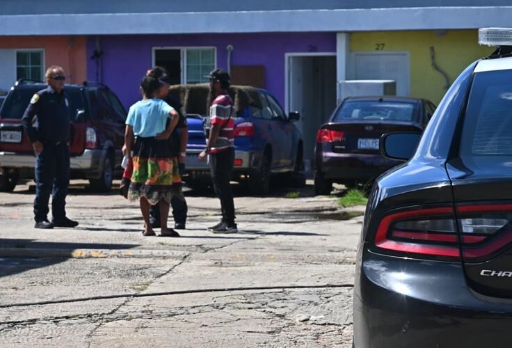 Police investigators on Wednesday June 14, 2023, speak to the parents of a child killed after a hit-and-run in the Family Apartments parking lot in Tamuning. The incident occurred early Tuesday evening.