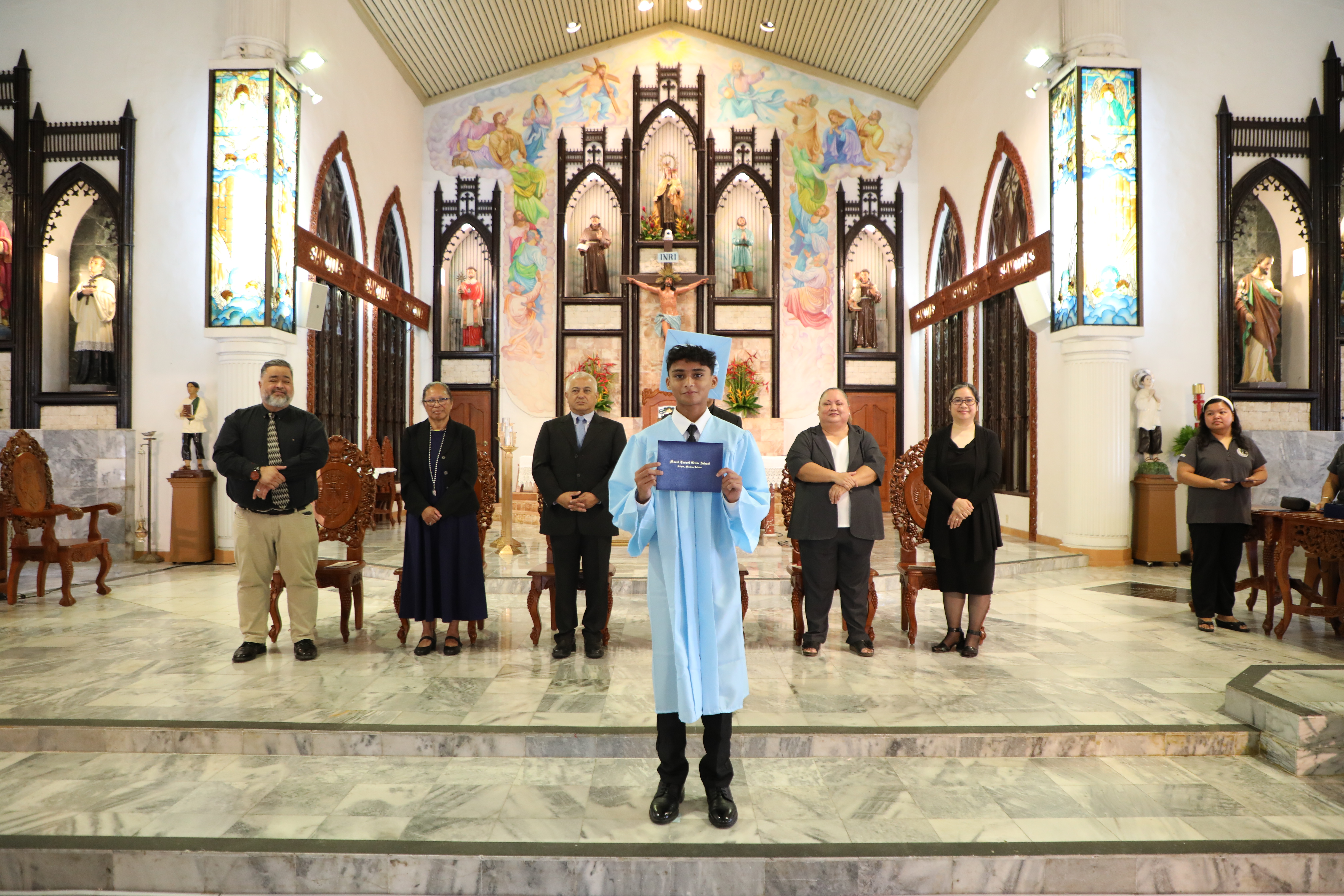 Mount Carmel School student Taher Shakir receives his diploma during the school’s 12th-Grade Commencement Ceremony on June 3, 2023.