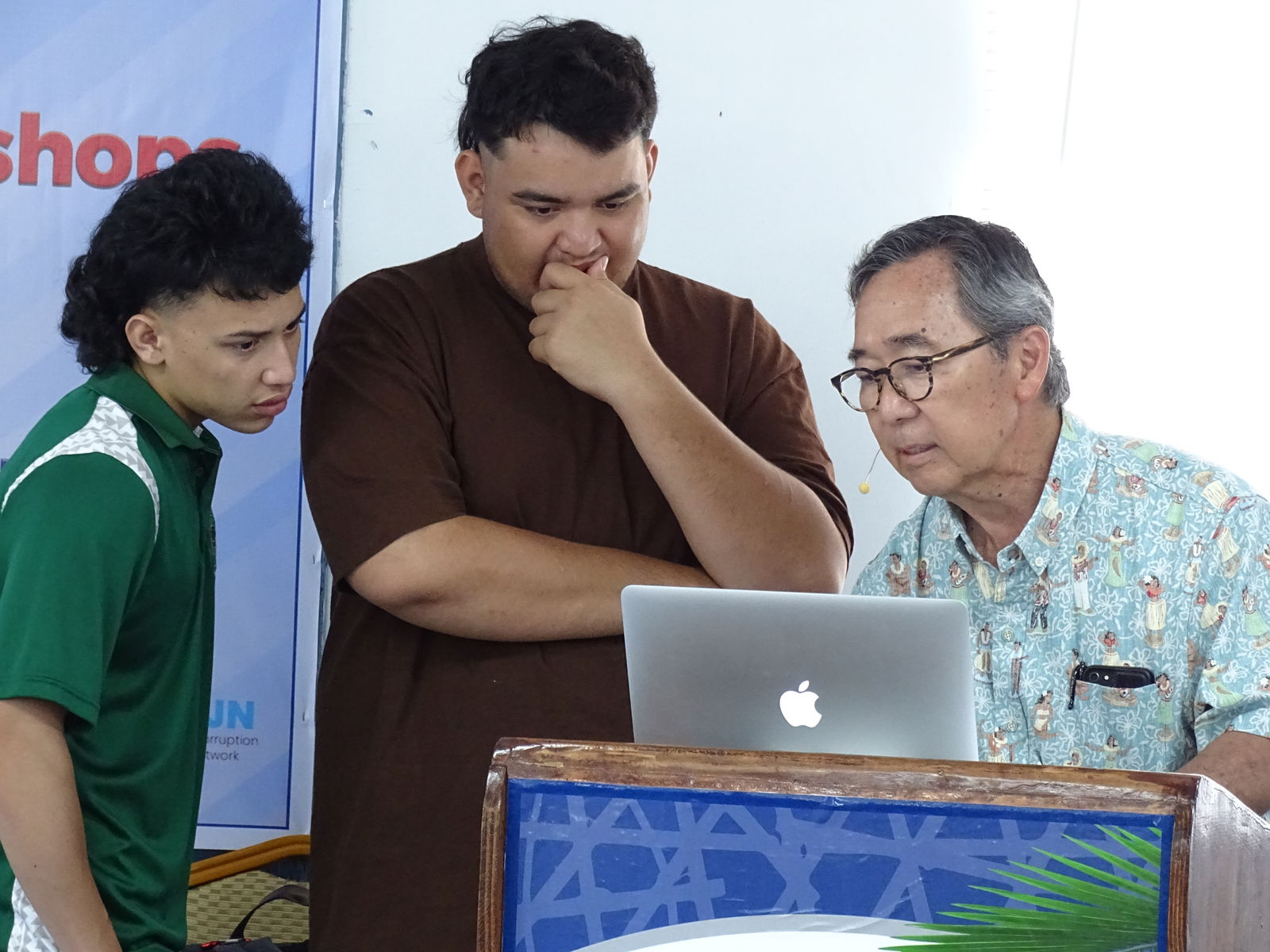Media and Democracy workshop participants Yale Kramer and Tinong Kramer review an assignment with lead workshop trainer Floyd K. Takeuchi.