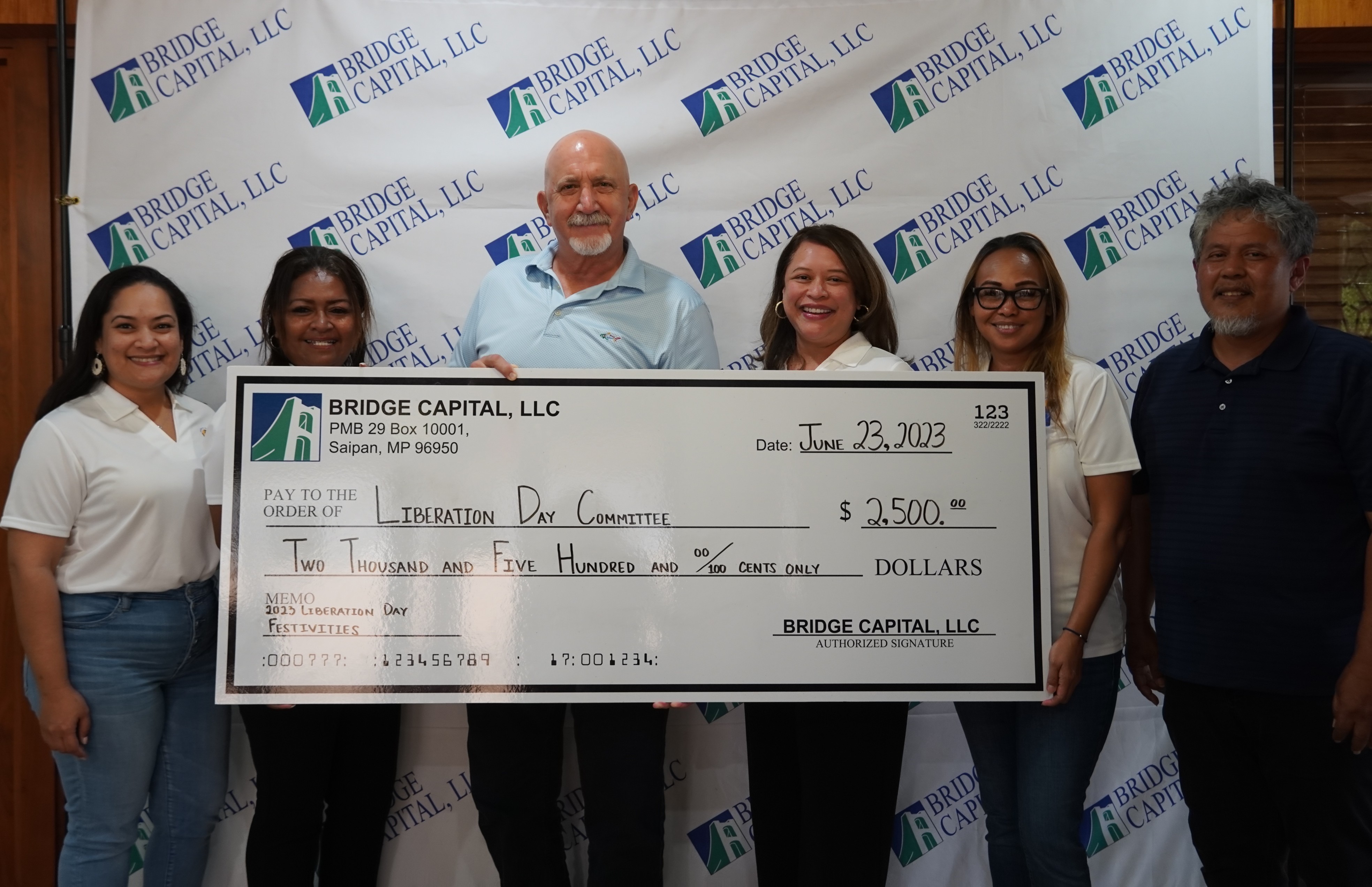 From left, Liberation Day Committee Board Member, Natashia Tomokane,  Hospitality Committee’s Joy Maratita, Bridge Capital LLC President and General Manager Bartley Jackson, Liberation Day Committee Chairwoman Nadine Deleon Guerrero, Hospitality Committee’s Carla Sablan and Gregorio Sablan pose for a photo during the presentation of Bridge Capital's sponsorship on June 23, 2023.