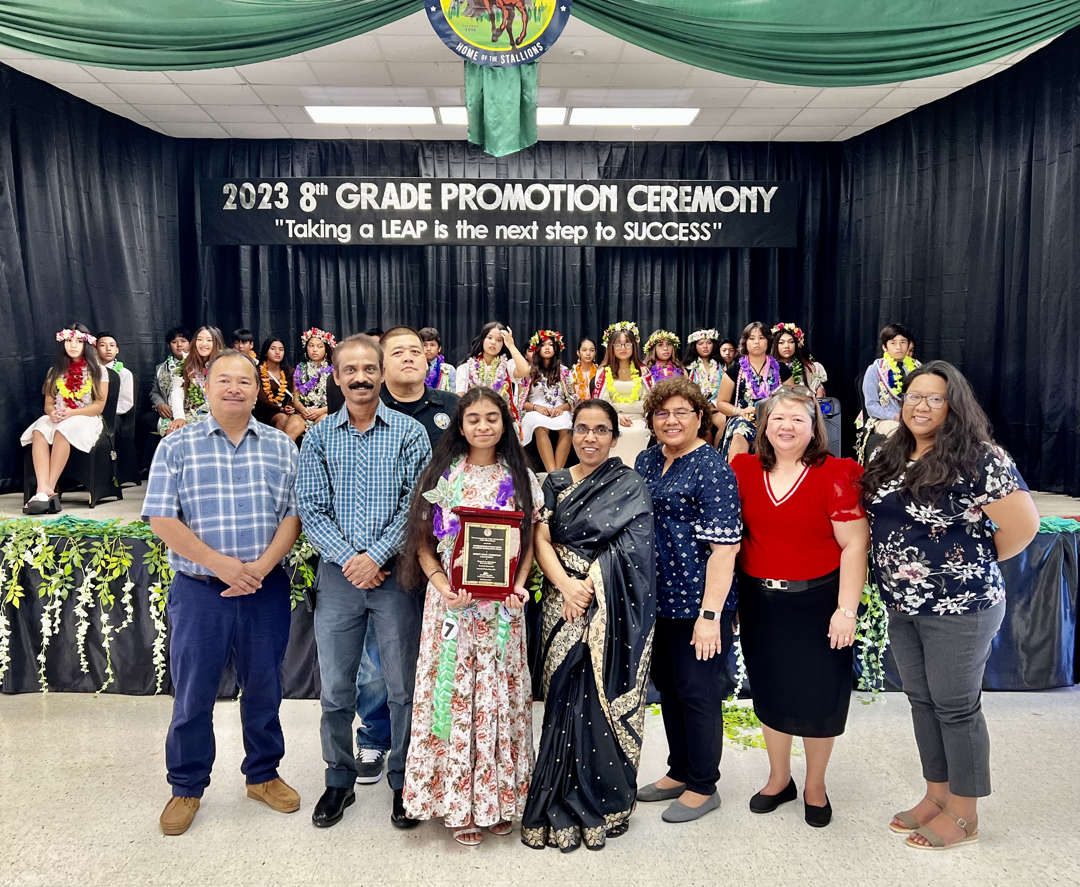 Salutatorian Mercy Anne Christian with her parents, Commissioner Dr. Alfred B. Ada and other Public School System officials.