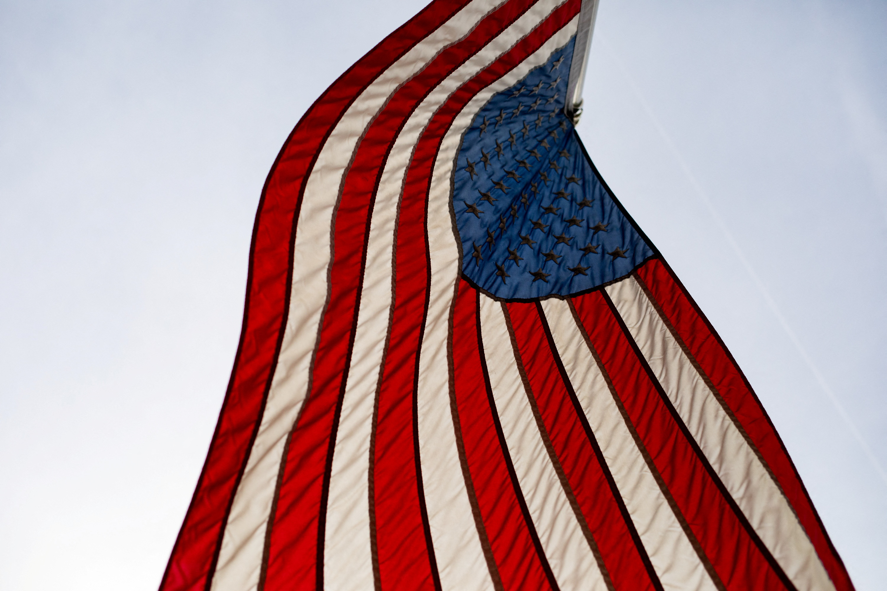 FILE PHOTO: An American flag blows in the wind in Hillsdale, Michigan, U.S., February 8, 2023. REUTERS/Emily Elconin/ File Photo