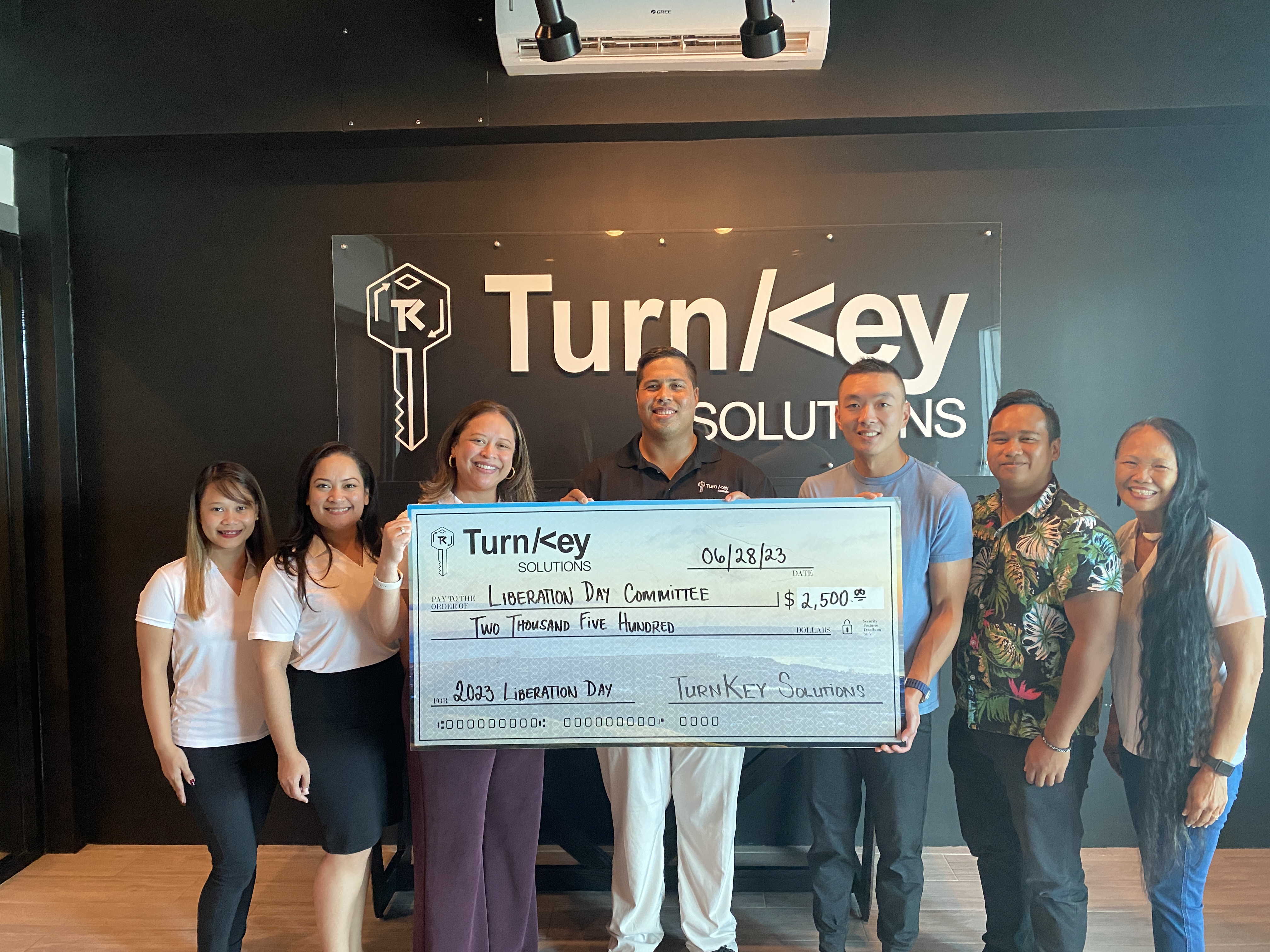 Liberation Day Committee Vice Chairwoman Diane Matsutaro, Board Member Natashia N. Tomokane, Chairwoman Nadine Deleon Guerrero, TurnKey Solutions Managing Partner Billy Grow, Managing Partner Jerry Lin, staff member, and LDC Hospitality Chairwoman Frances Sablan.