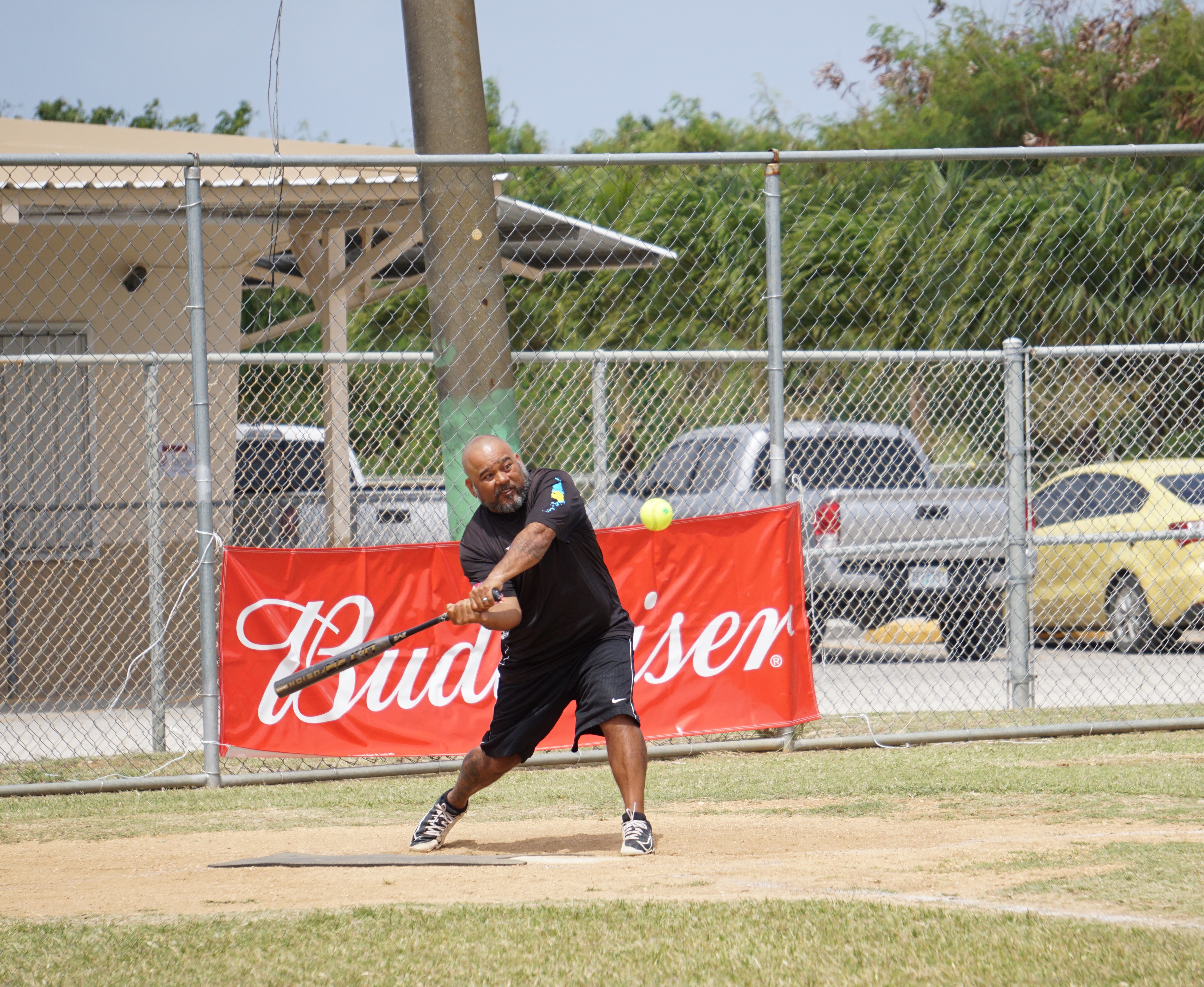 Asahi's Edgar Ito connects a hit during a 2023 Budweiser Belau Amateur Softball League game at the Dandan baseball field.