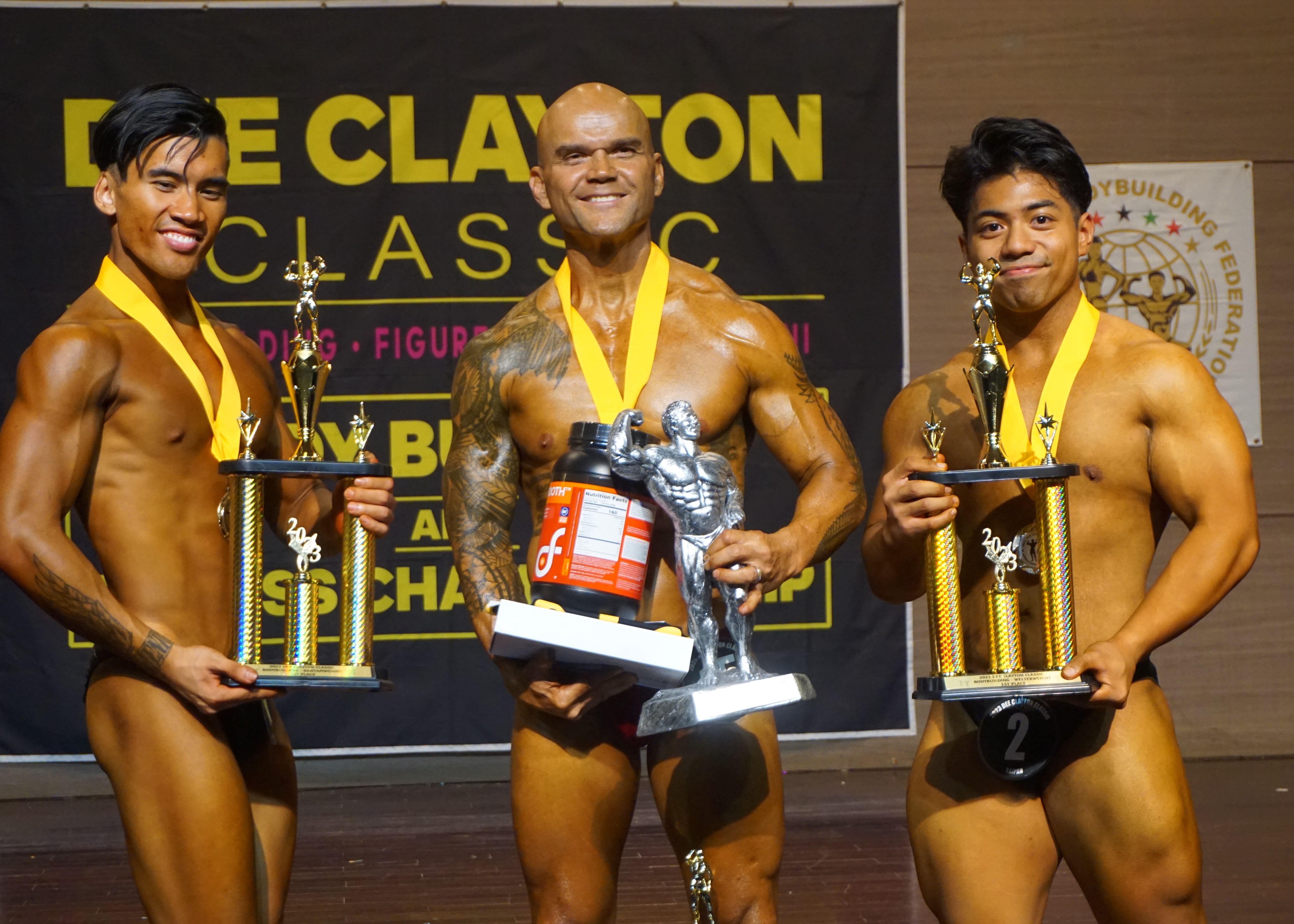 Stanley Iakopo, center, holds the overall bodybuilding trophy as he poses for a photo with bantamweight first place Lorenzo Sanchez, left, and welterweight first place Ralph Villas at the conclusion of the 2023 Dee Clayton Classic & Northern Marianas Bodybuilding Federation competition at Saipan World Resort's Taga Hall.