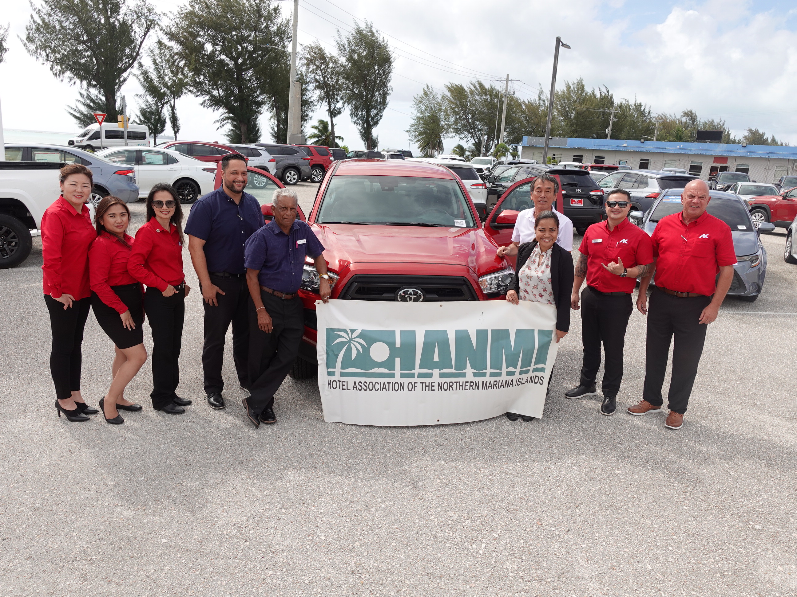Atkins Kroll  Saipan Sales Manager Kevin Barnes, fourth left, presents a 2023 Toyota Tacoma PreRunner Double Cab as a hole-in-one prize for the 21st Annual HANMI Charity Classic Golf Tournament, scheduled for July 15, 2023, at LaoLao Bay Golf & Resort west course. Also pictured are tournament committee chairman Juko Ishikawa, fourth right, and other AK Saipan management and staff and committee members.