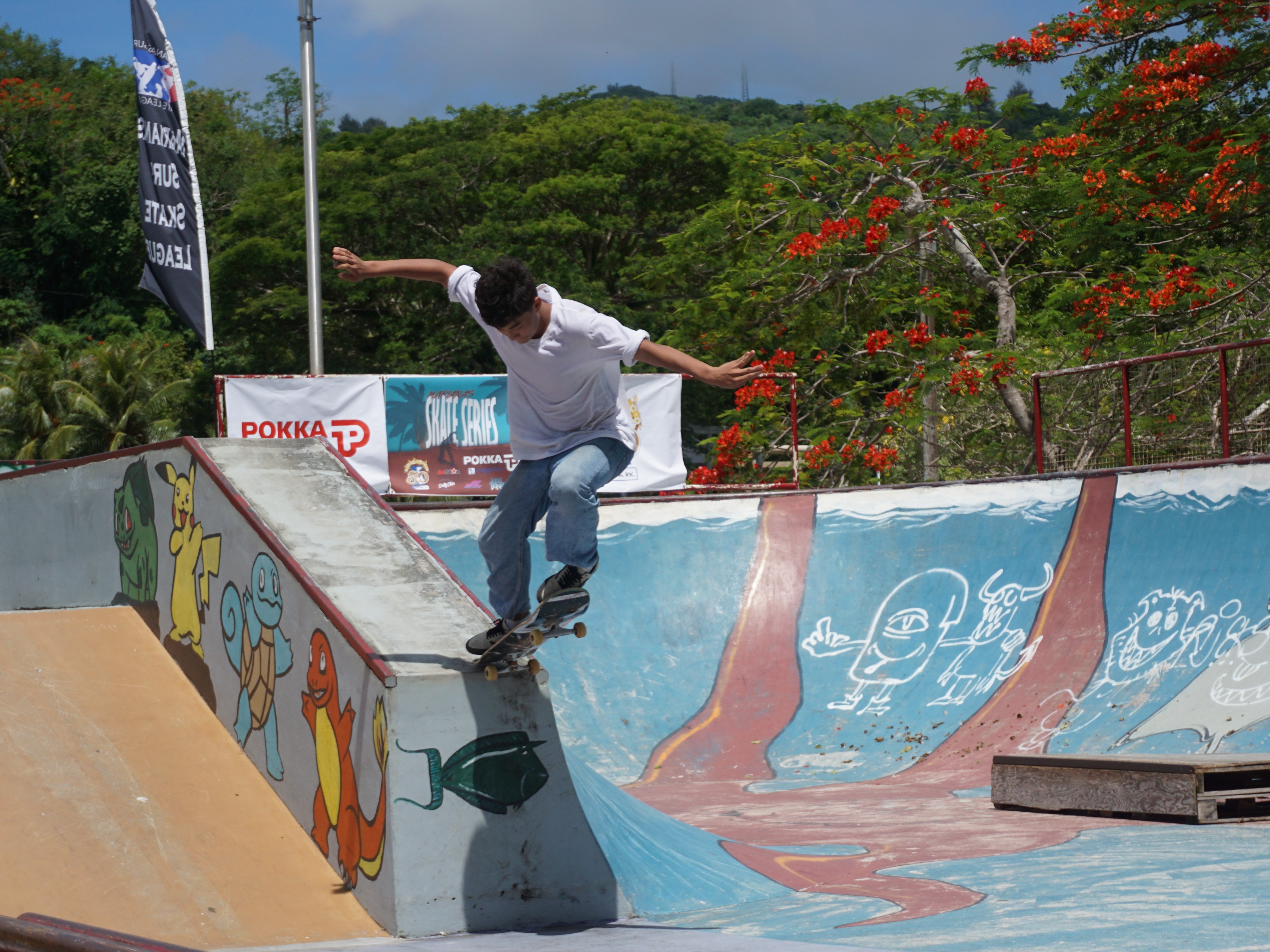 Sean Gil takes off from the ledge of the pool and sticks the landing.