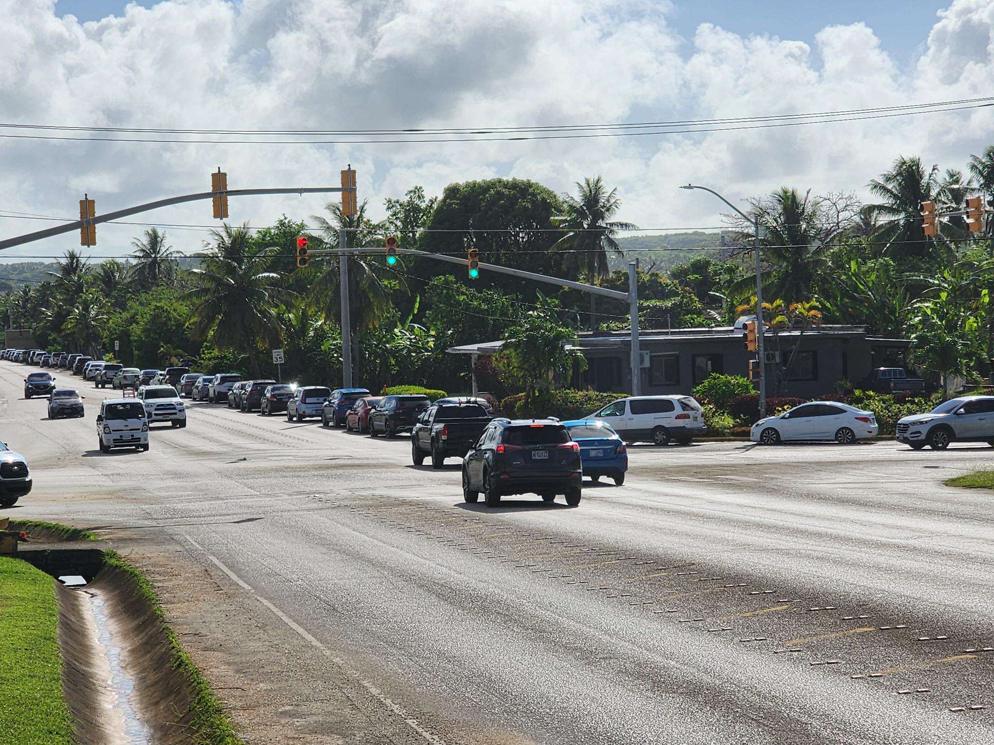 The vehicles lining up for the P-EBT summer drive-thru distribution can be seen as far as As Perdido Road.