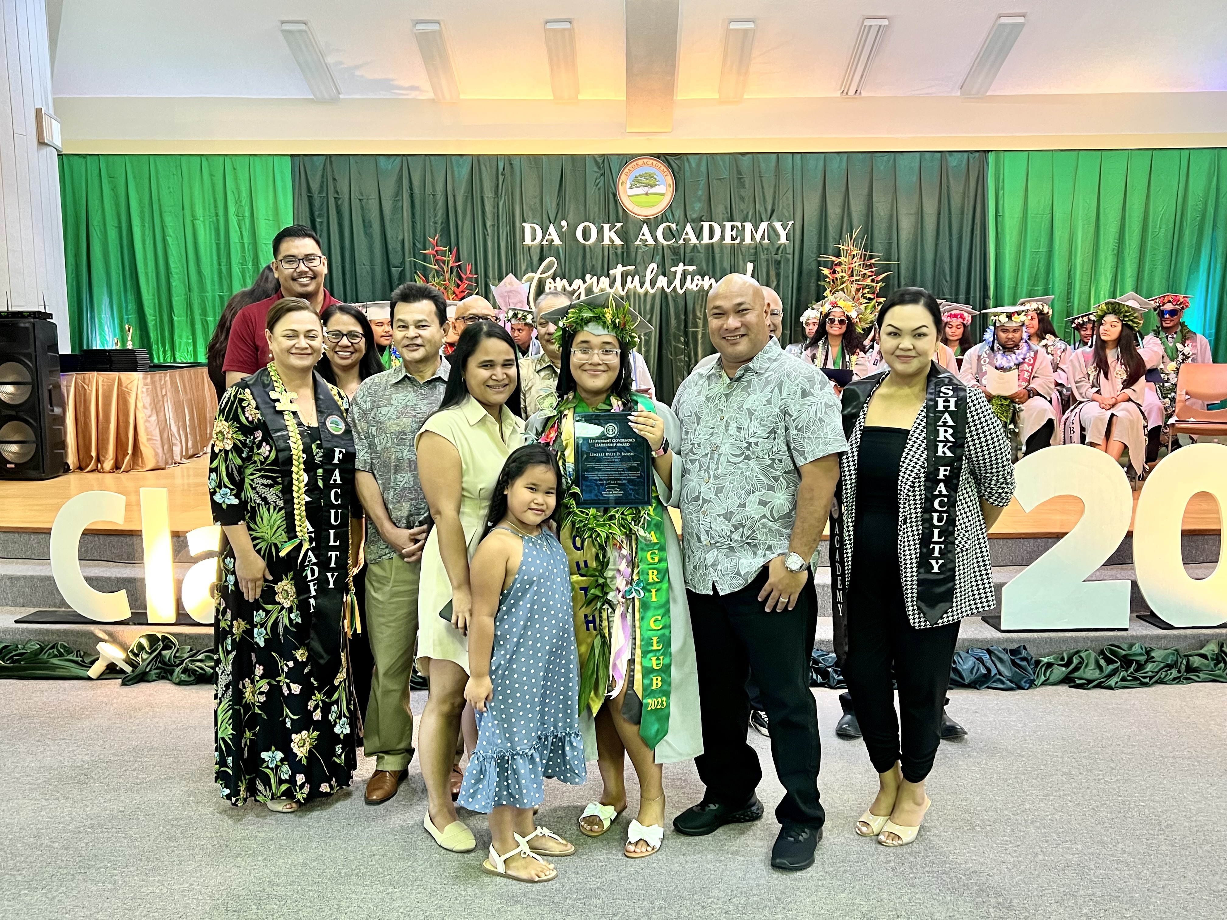 The Lt. Governor’s Leadership Award was presented to Lenelle Rylie D. Bansil by Lt. Gov. David M. Apatang’s Chief of Staff Henry S. Hofschneider. Also in photo are Bansil’s family, Da’ok Academy Principal Christine Tudela, Board of Education Chairman Antonio L. Borja, Vice Chairman Herman Atalig, Secretary/Treasurer Gregory Pat Borja, Member Maisie B. Tenorio, Member Andrew Orsini and Commissioner of Education Dr. Alfred B. Ada.