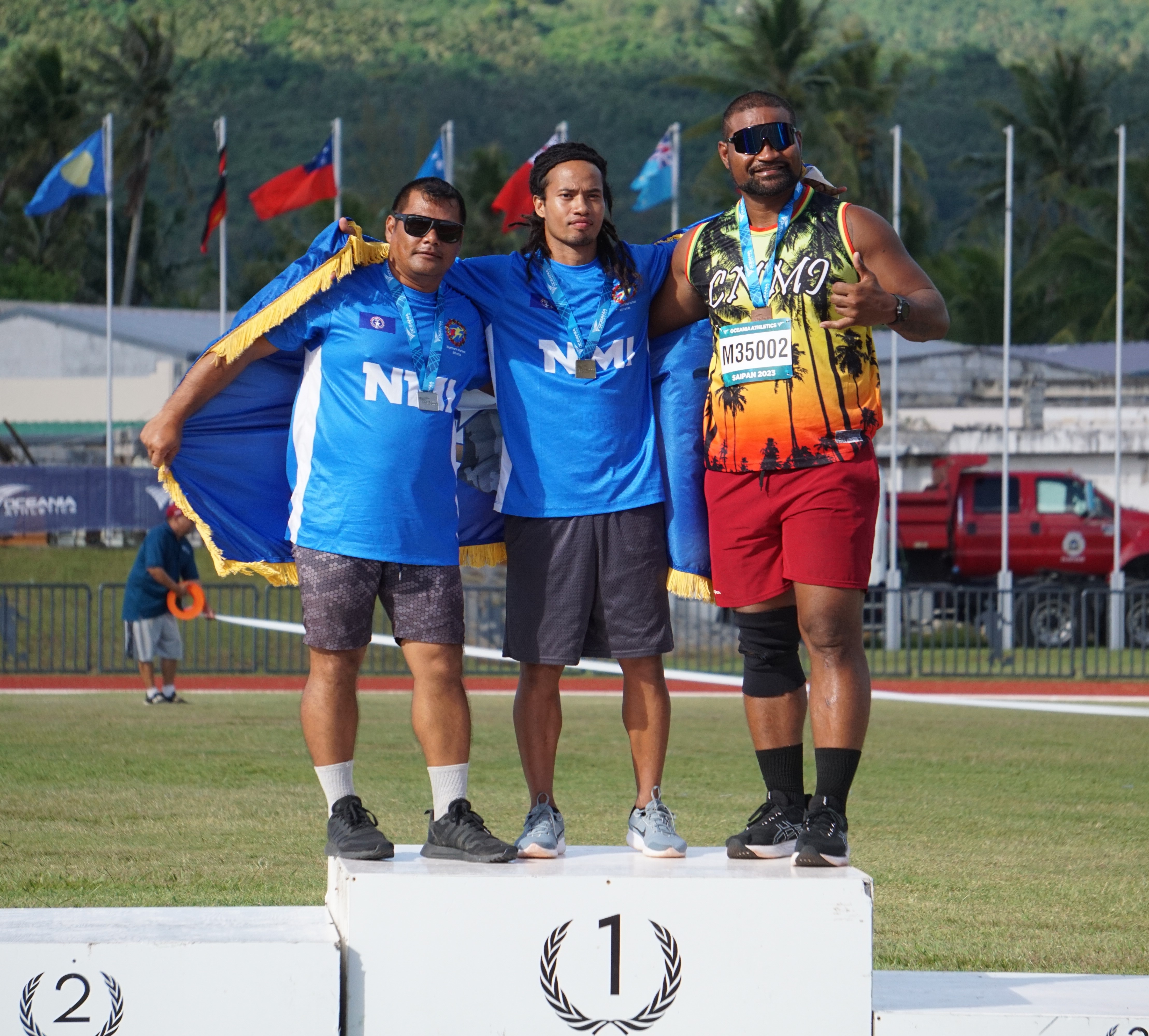 Leo Wania, Orrin Pharmin, and Kelvin Fitial pose with their medals.