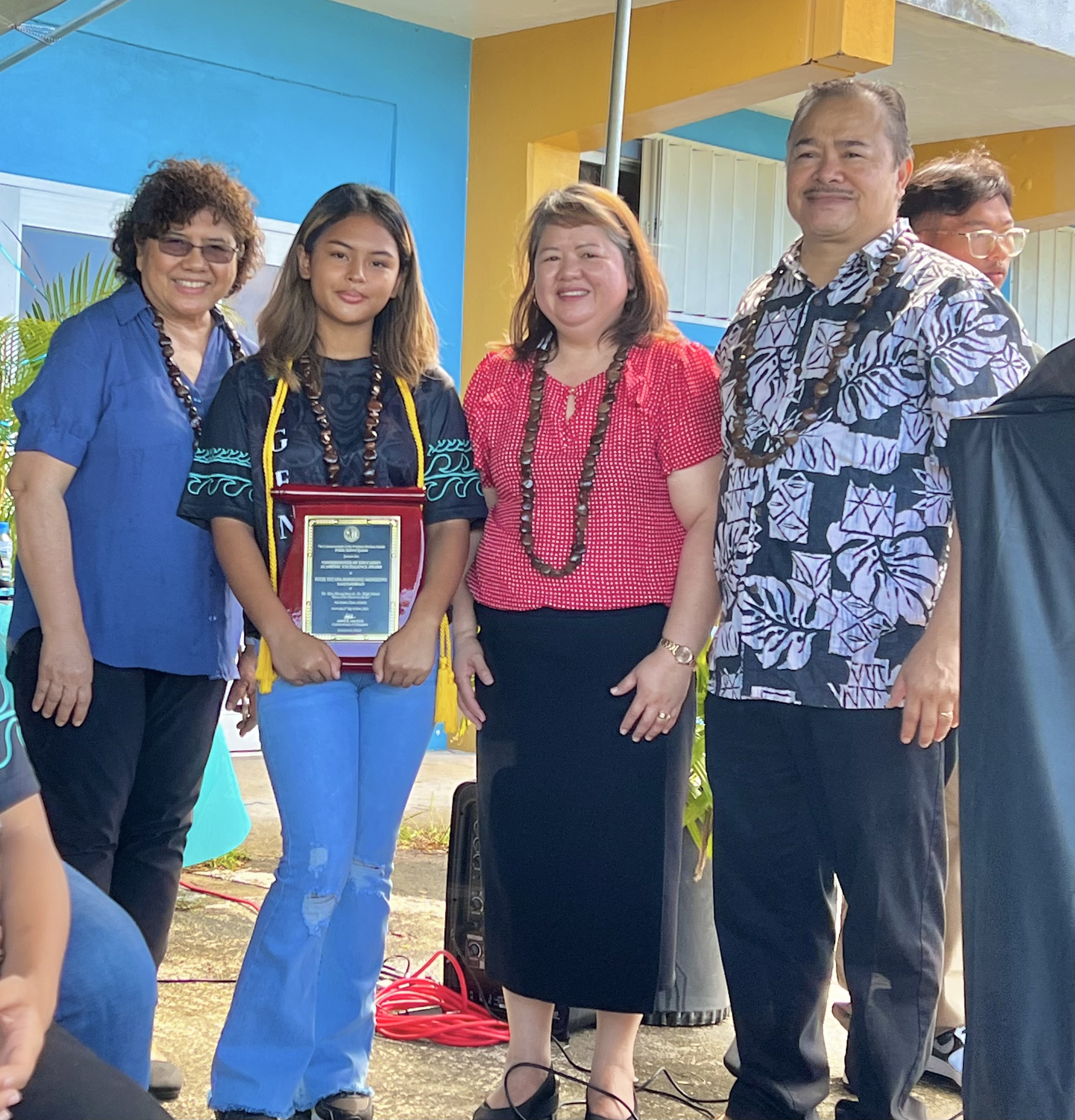Kylee Dee’ara Manalang Manglona, the class salutatorian, with Education Commissioner Alfred B. Ada, Senior Directors Jackie Quitugua and Dr. Rizalina Liwag.