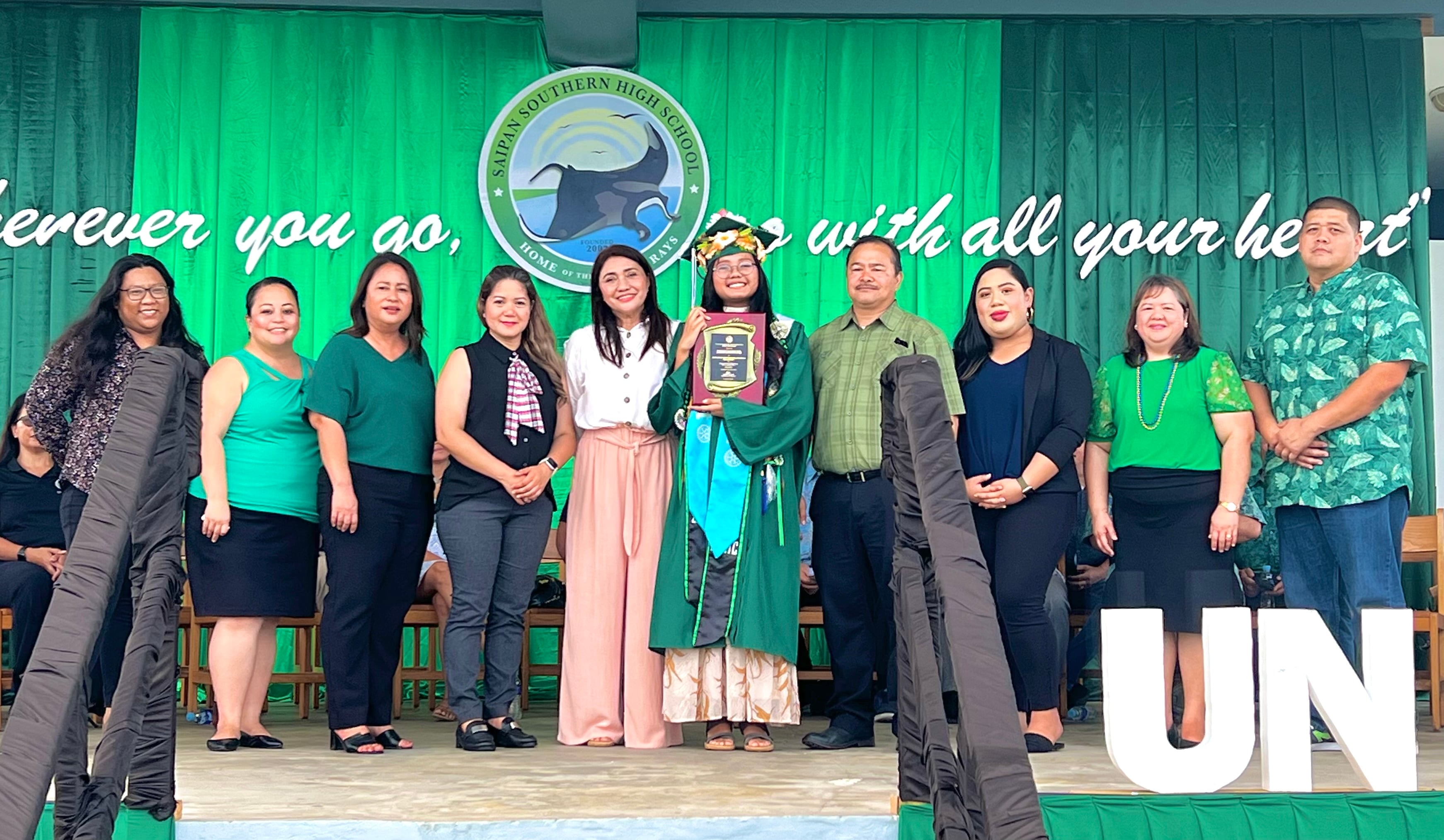 Class Salutatorian and Commissioner of Education Academic Excellence Award recipient  Aisha Erica M. Lansangan and her mother with Commissioner of Education Dr. Alfred B. Ada and Public School System officials Lorraine Catienza, Lucretia Deleon Guerrero, Dr. Yvonne R. Pangelinan, Arlene Lizama, Randee-Jo Barcinas-Manglona, Dr. Rizalina Liwag and Shawn San Nicholas.