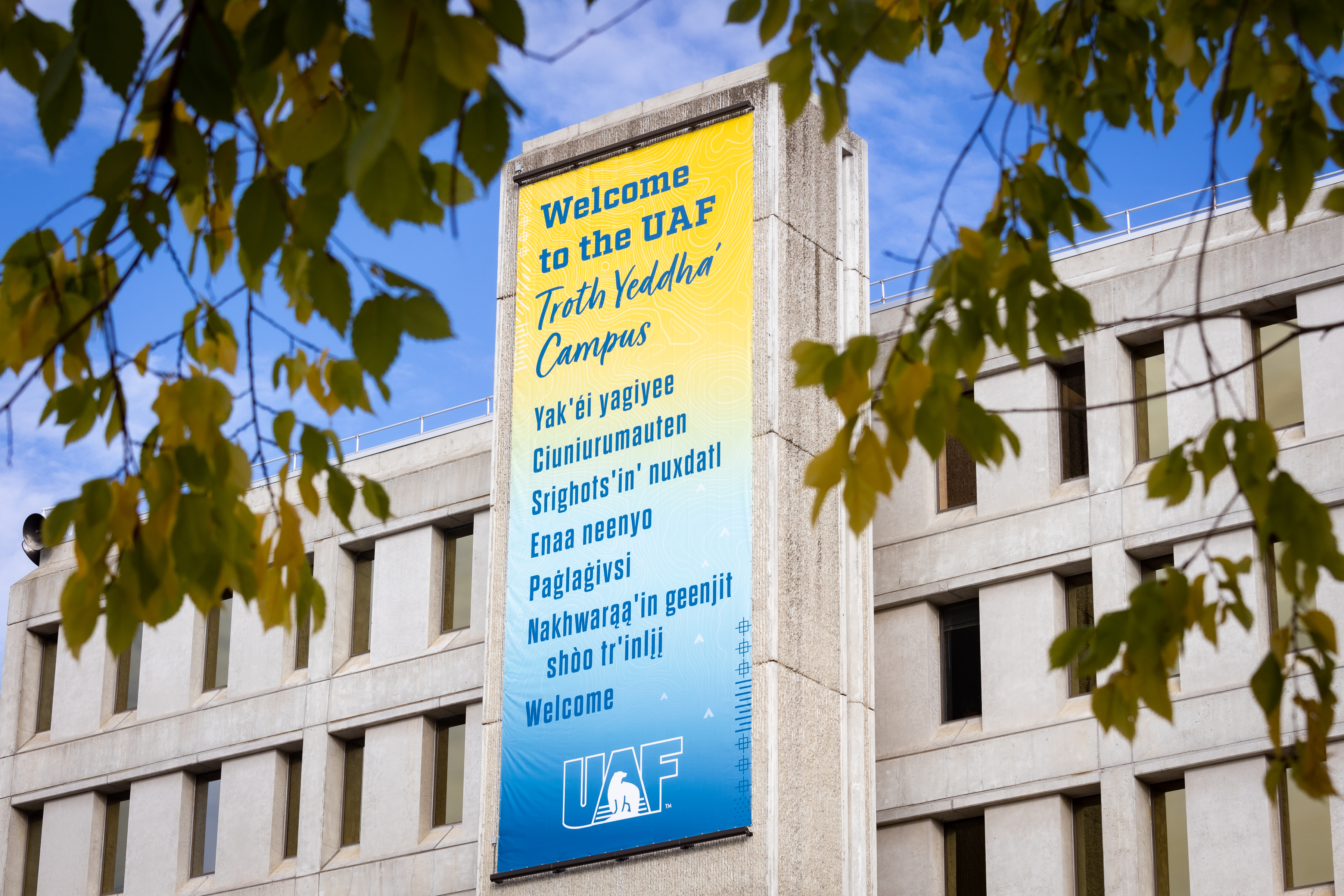 A banner on the University of Alaska Fairbanks’ Signers Hall welcomes students to the Troth Yeddha' Campus in several Alaska Native languages.