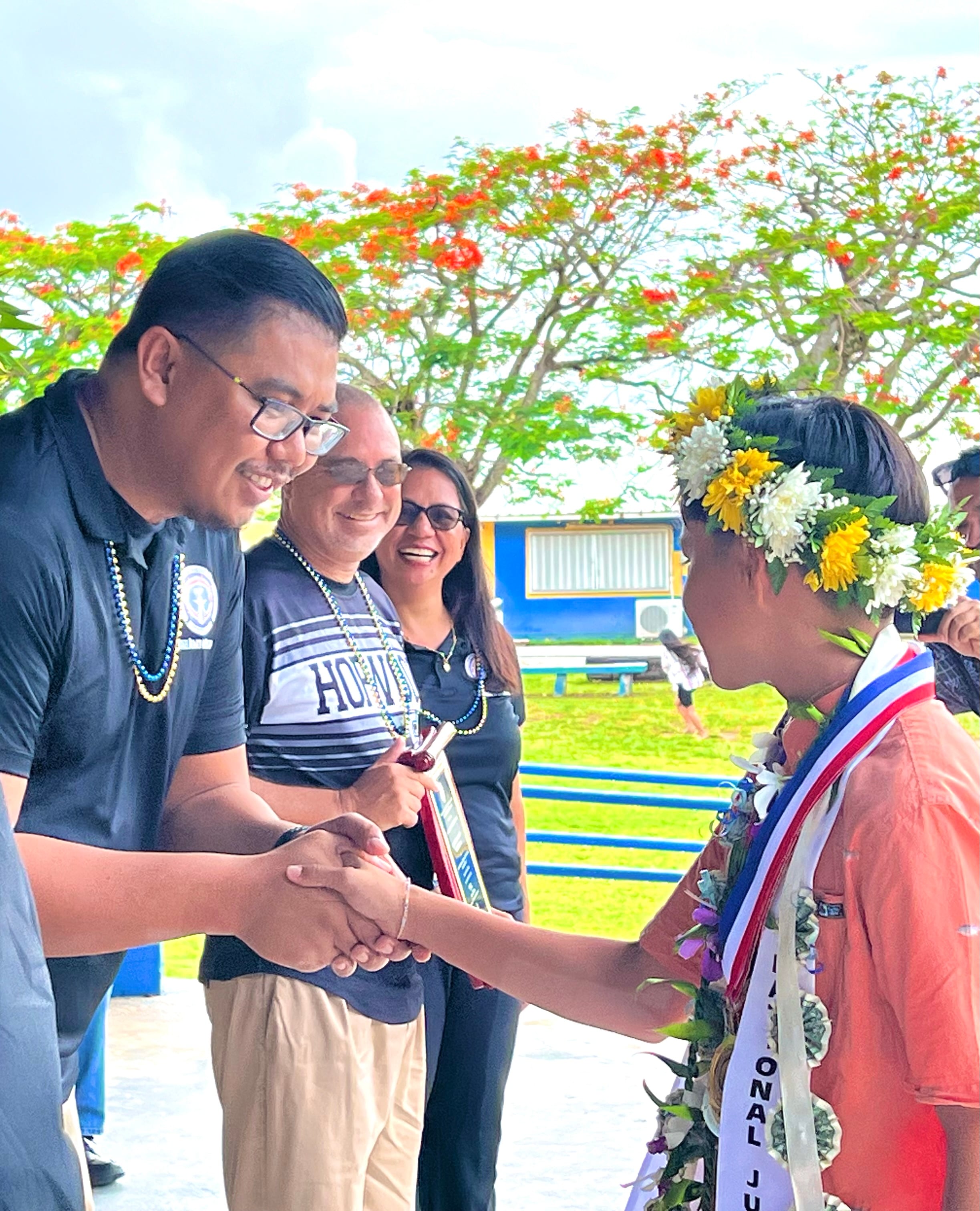 Class valedictorian John Peter Niniano Quidato is congratulated by Board of Education Chairman Antonio L. Borja, Secretary/Treasurer Gregory Pat Borja, and Board Member Maisie B. Tenorio