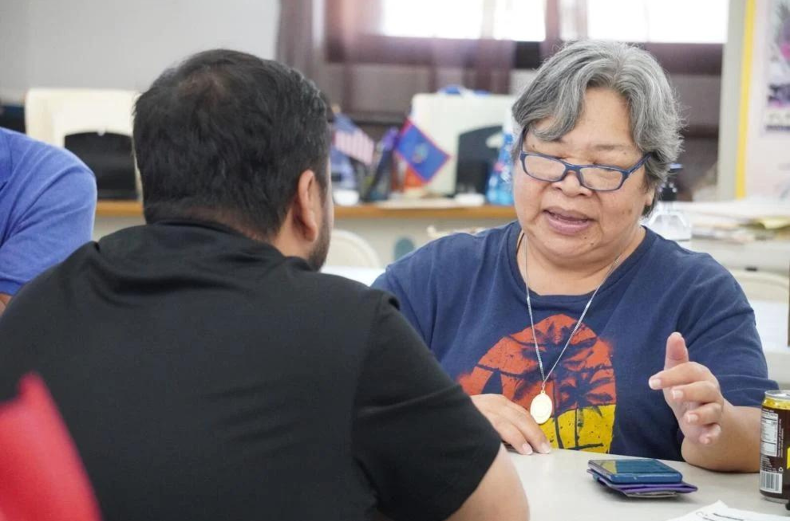 GTA employee Jesse Blas, left, assists Therese Naputi during the Manamko' Mobile Workshop at the Inalåhan Senior Center on May 15, 2023.