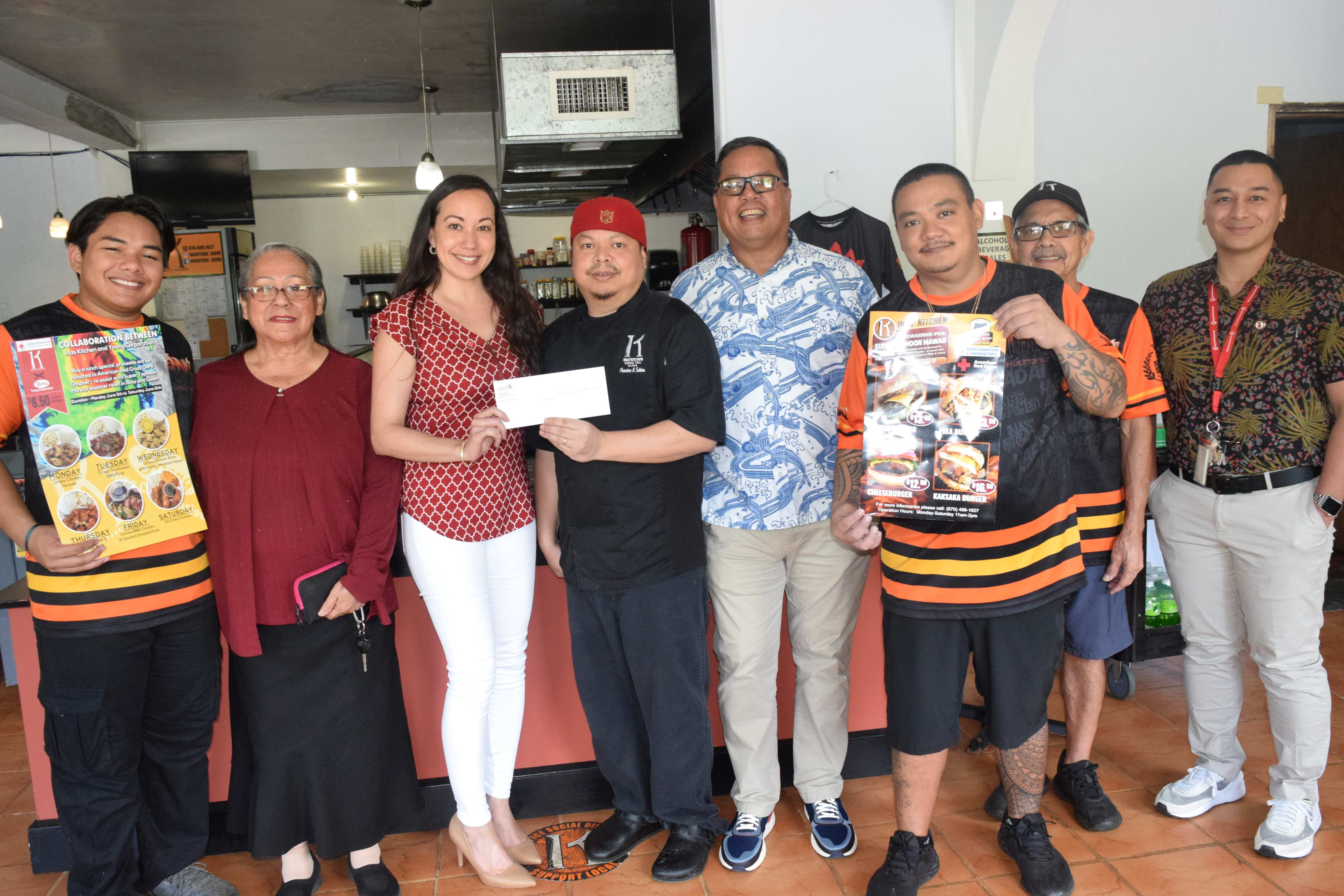 INAS' Kitchen Owner/Chef Sonnie A. Sablan, center, hands a donation to American Red Cross-NMI Chapter Board Member Patty Palacios, third left, on Thursday. Also in the photo are Triple J Payless SuperFresh & Truckload Store General Manager Jay Santos, fourth right, Yaong Corporation Sales and Liaison Officer Ma. Therese H. Aldan, second left, INAS' Kitchen President Frank Sablan, second right, ARC-NMI Chapter Board Member Brent Deleon Guerrero, right, and INAS Kitchen staff.