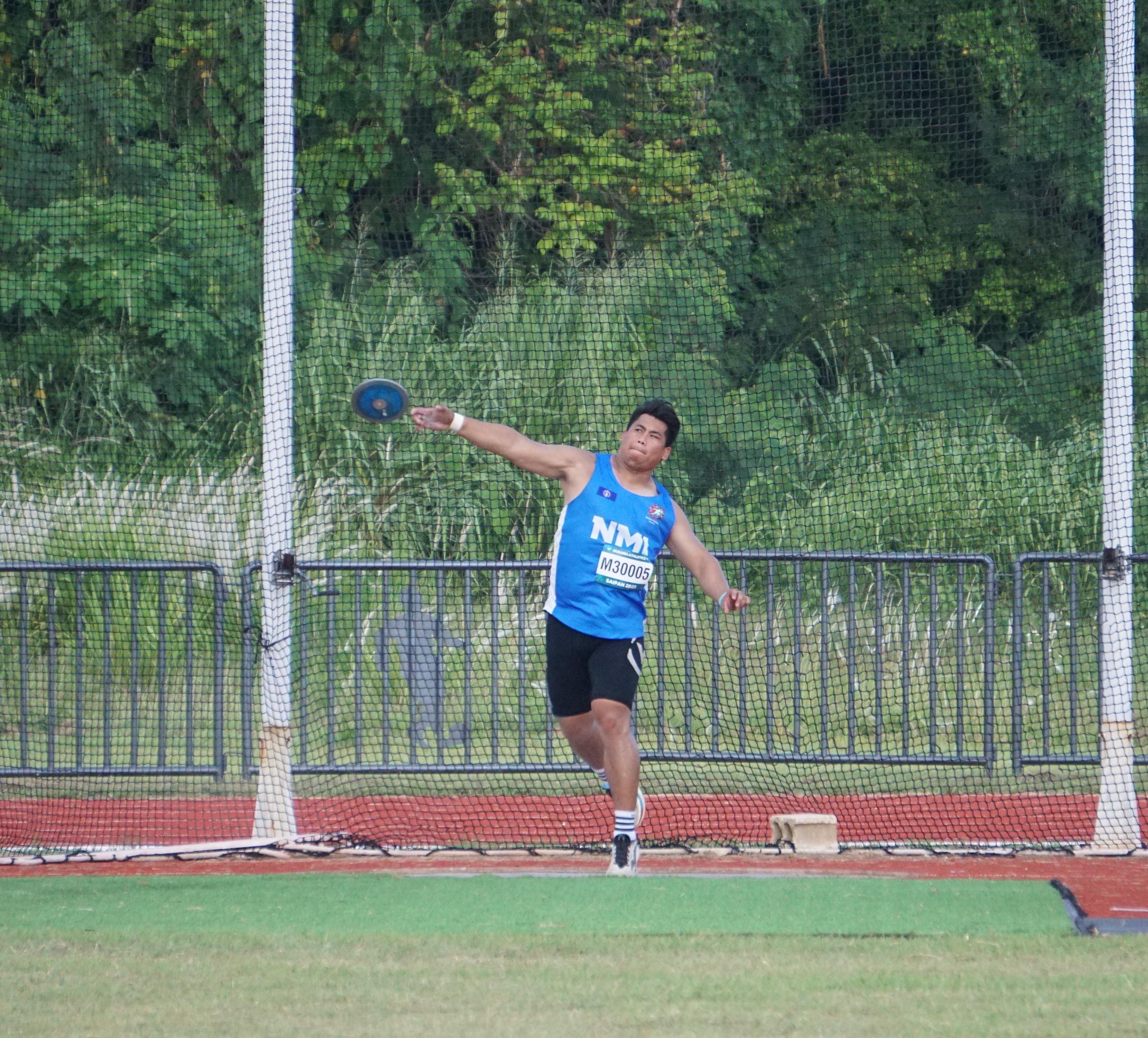 Angel San Nicolas throws the shotput.