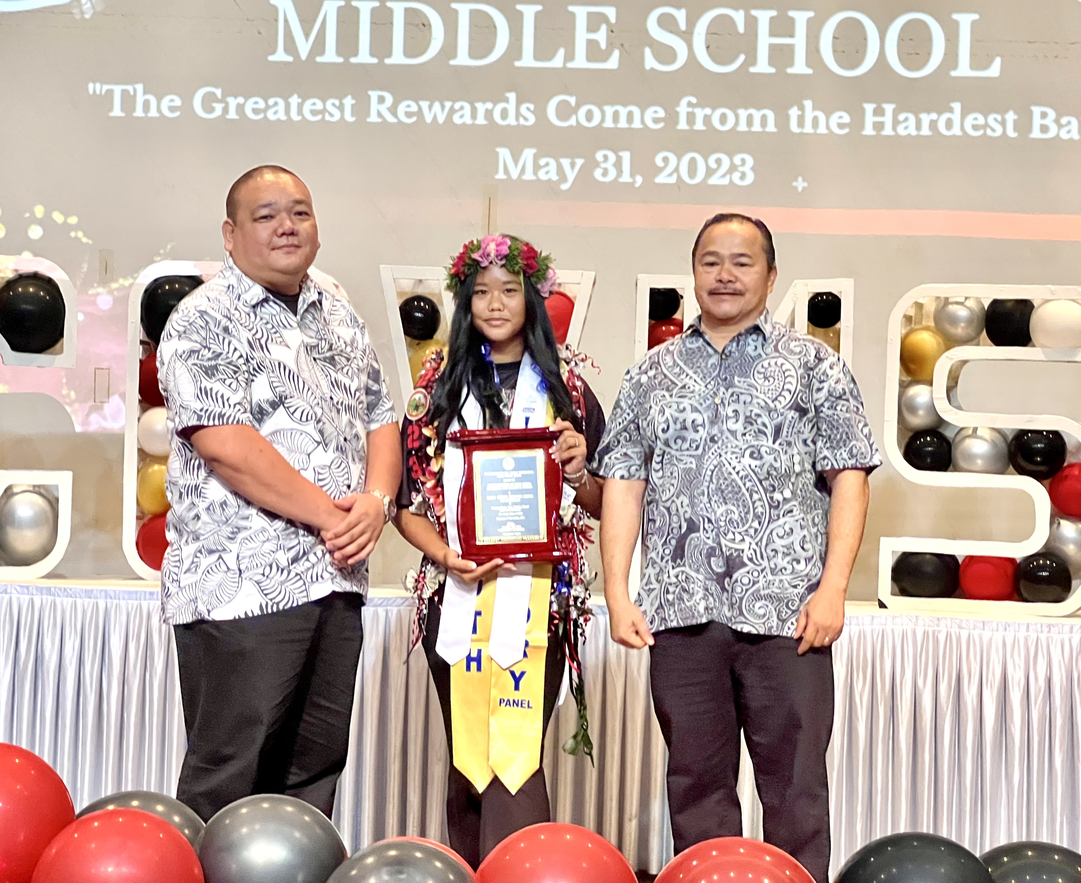 Salutatorian and Commissioner of Education Academic Excellence Award recipient Mary Devine Esteves Amog, center, with Commissioner of Education Dr. Alfred B. Ada, right, and Associate Commissioner for Administrative Services Eric Magofna.