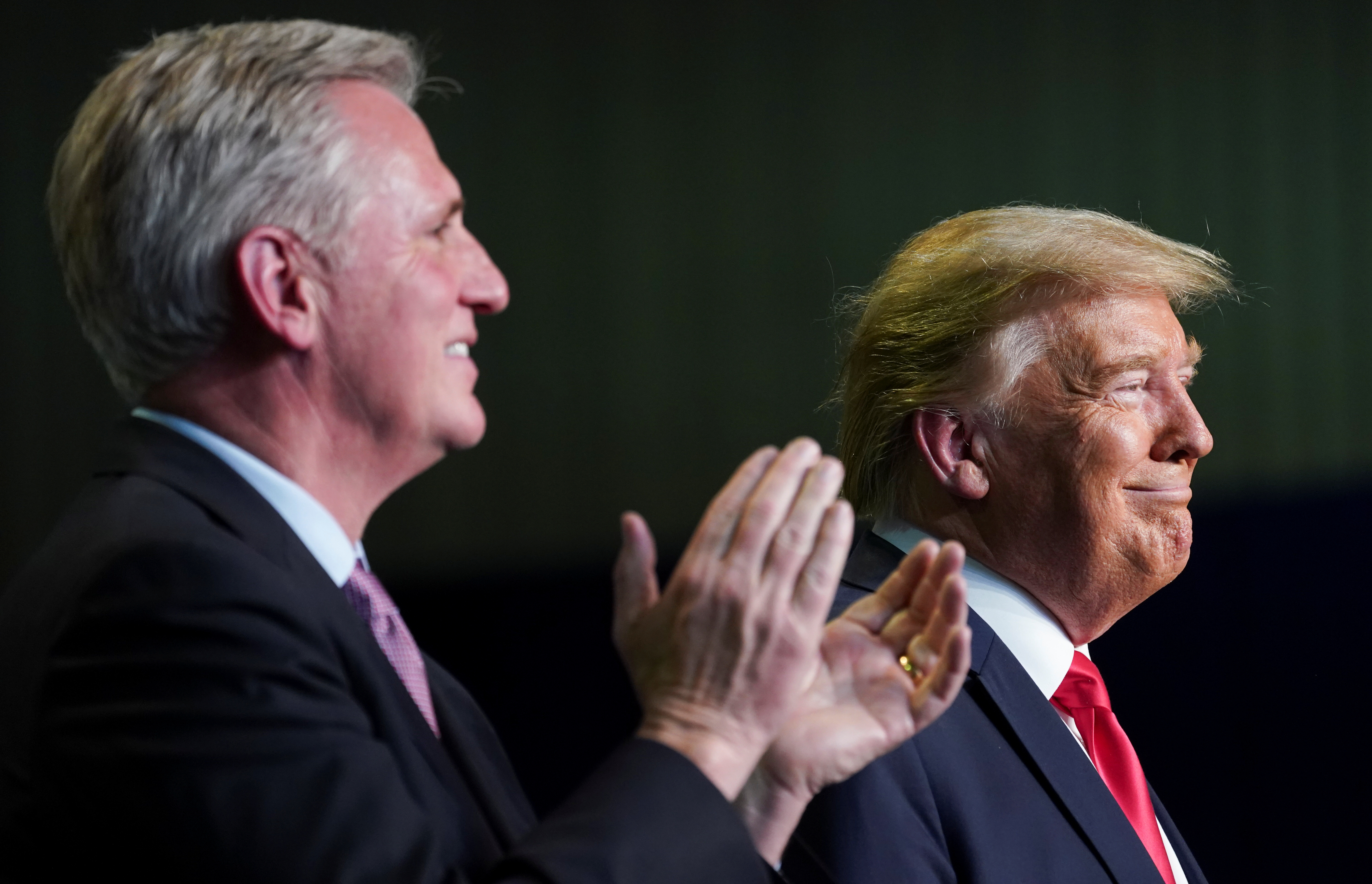 FILE PHOTO: House Republican leader Kevin McCarthy (R-CA) applauds as he and U.S. President Donald Trump take part in an event on water accessibility for farms during a visit to Bakersfield, California, February 19, 2020. REUTERS/Kevin Lamarque