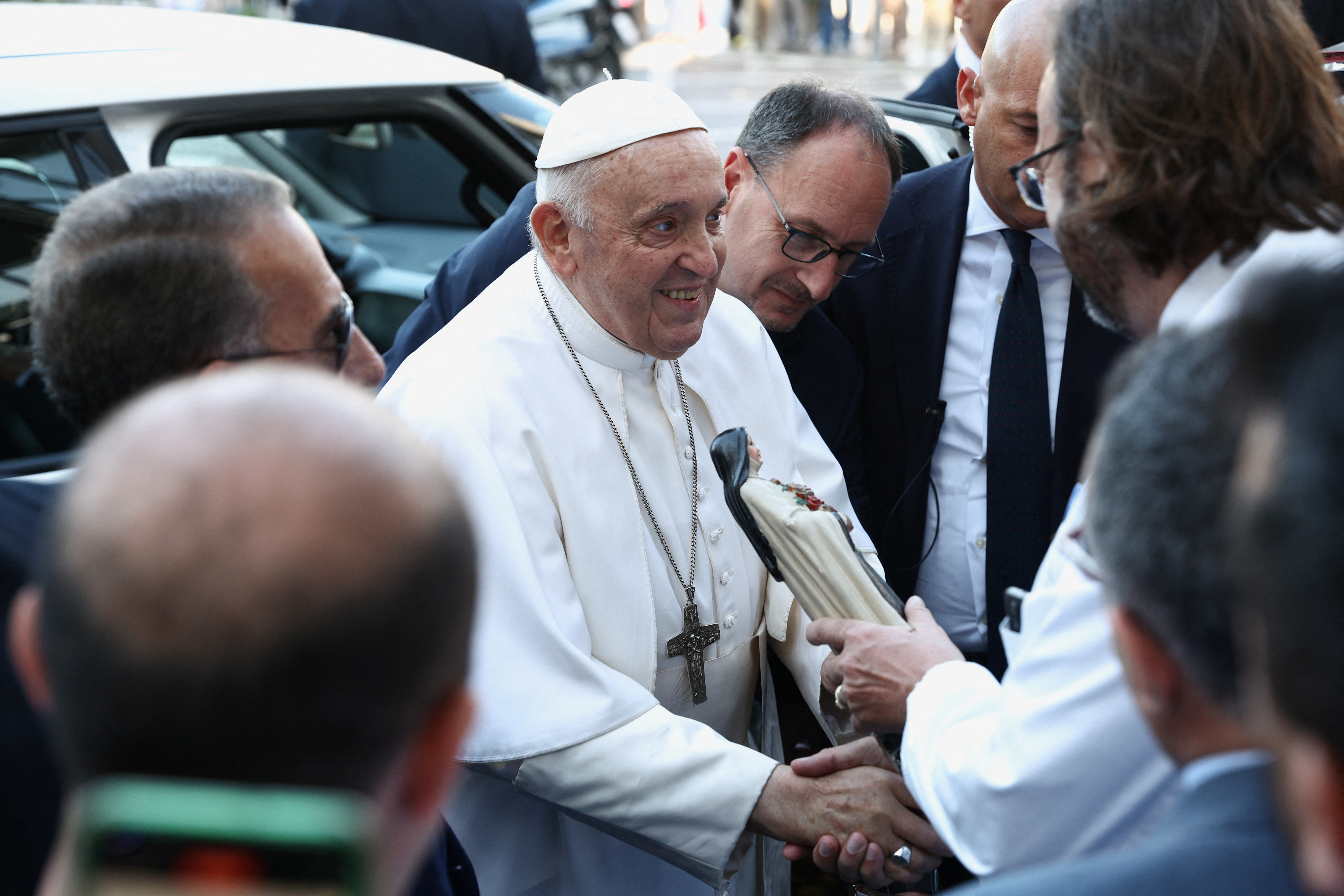 Pope Francis greets people after having been discharged from Gemelli Hospital in Rome, Italy, June 16, 2023. REUTERS/Guglielmo Mangiapane