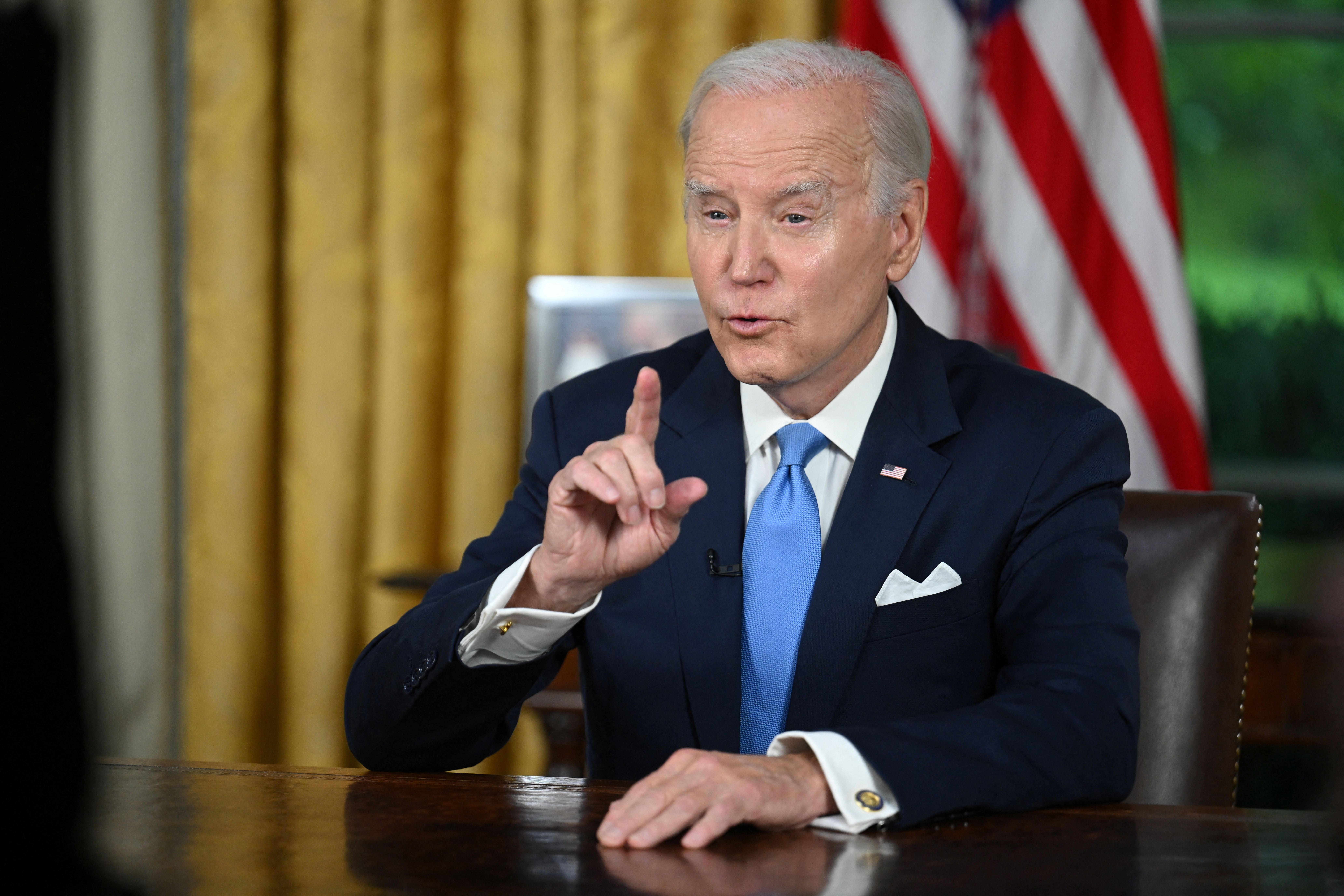US President Joe Biden addresses the nation on averting default and the Bipartisan Budget Agreement, in the Oval Office of the White House in Washington, DC, June 2, 2023. JIM WATSON/Pool via REUTERS