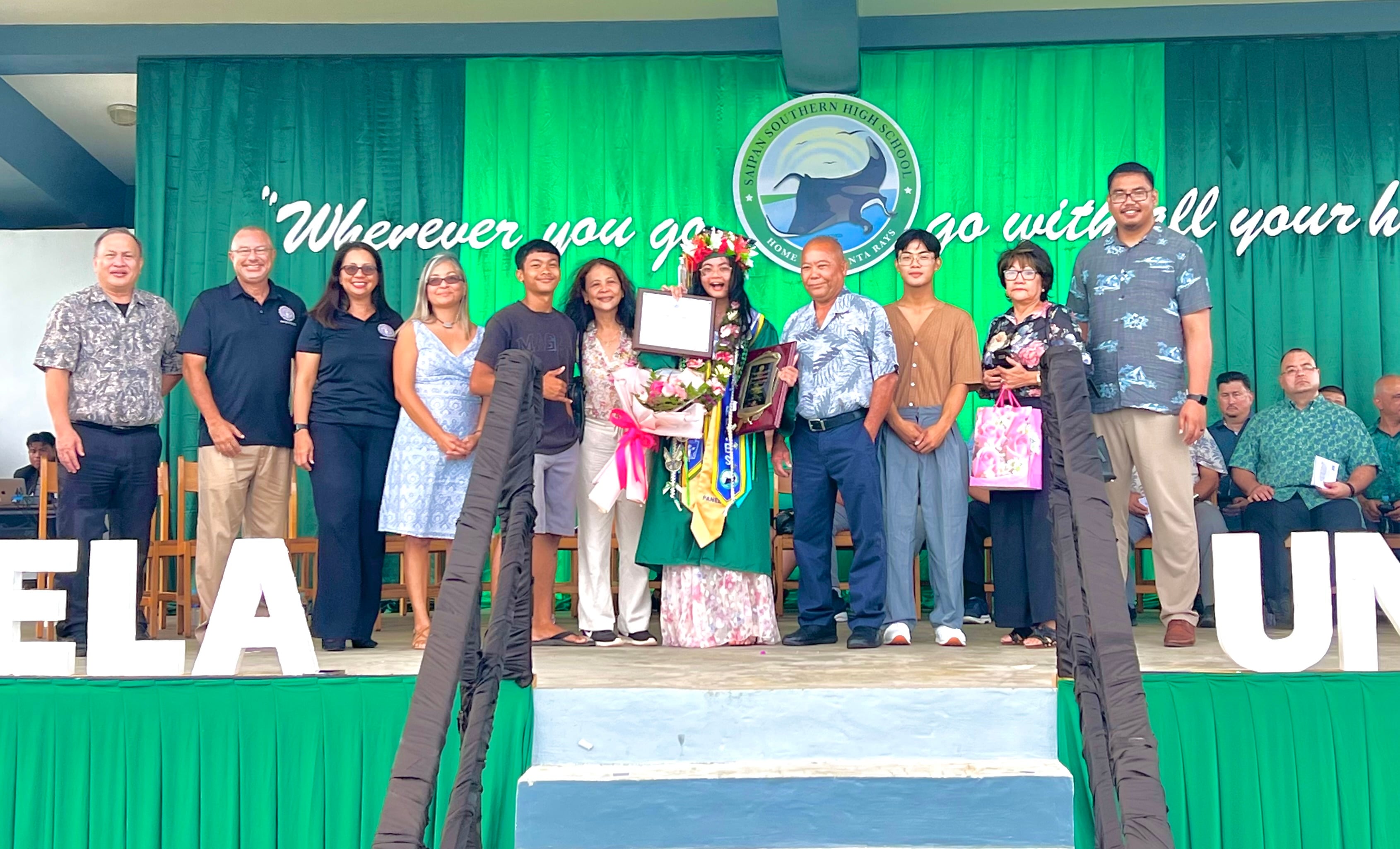 Class Valedictorian and Board of Education Academic Award recipient Jessie Lynn I. Reyes and her family with BOE Chairman Antonio L. Borja, Secretary/Treasurer Gregory Pat Borja, Member Maisie B. Tenorio,  Member Andrew L. Orsini and Teacher Representative Dr. Dora B. Miura.