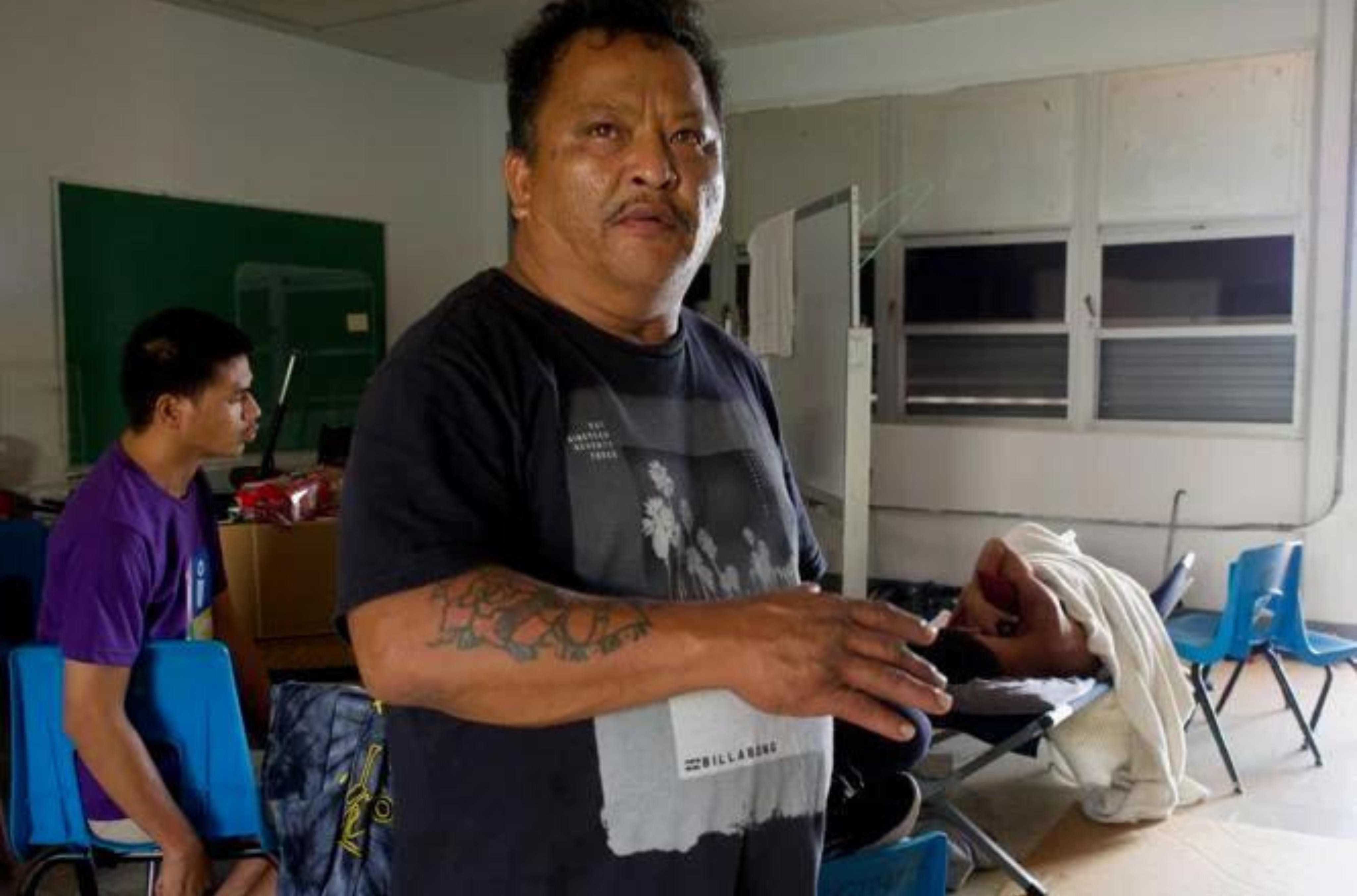 Jess Quichocho, Lori Quichocho's husband, describes the struggle to keep himself and his asthmatic children healthy, as they shelter without water or power Friday, June 2, 2023, at Astumbo Elementary School in the aftermath of Typhoon Mawar. 