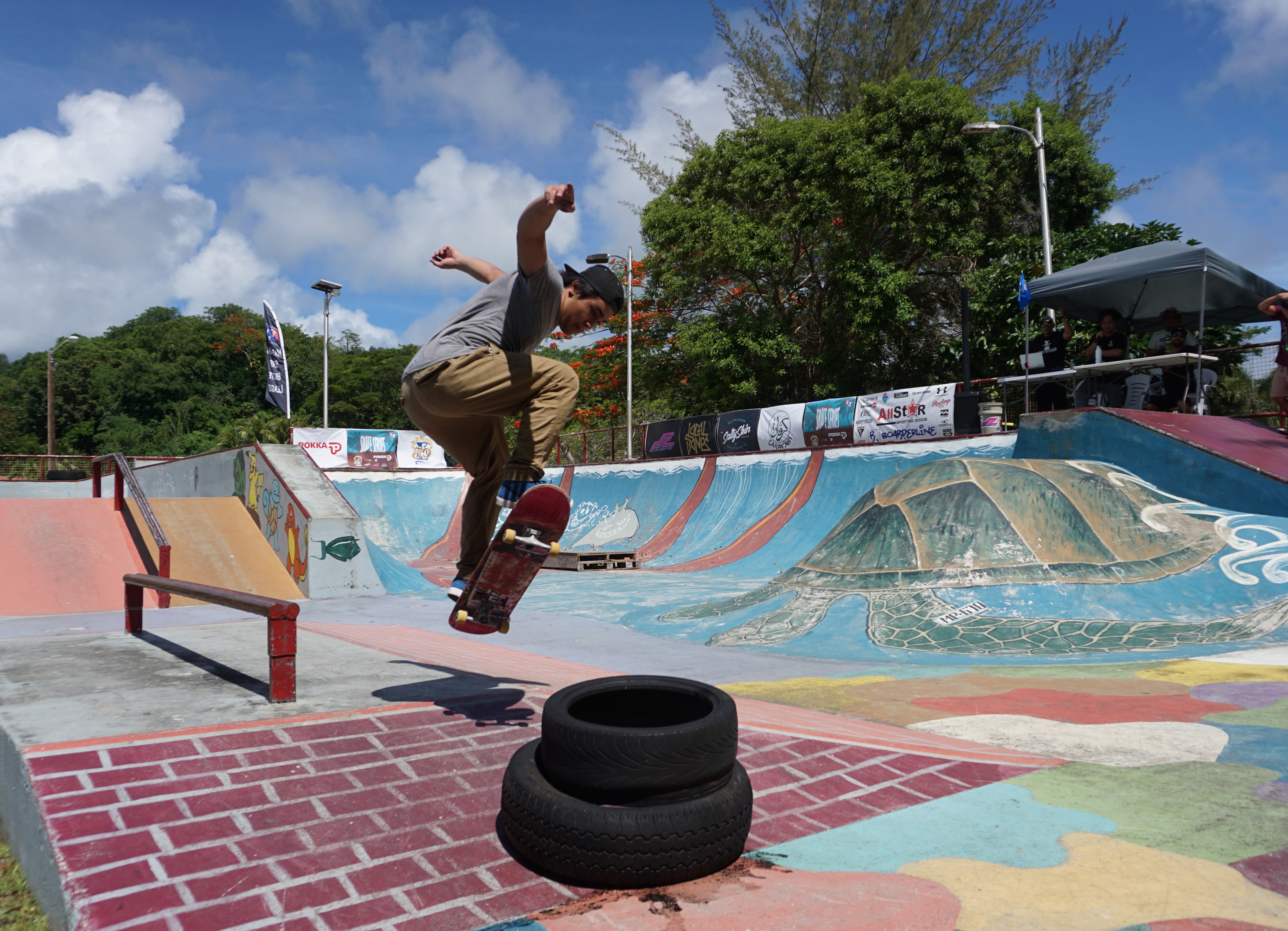 Miles Borja ollies over a stack of tires.