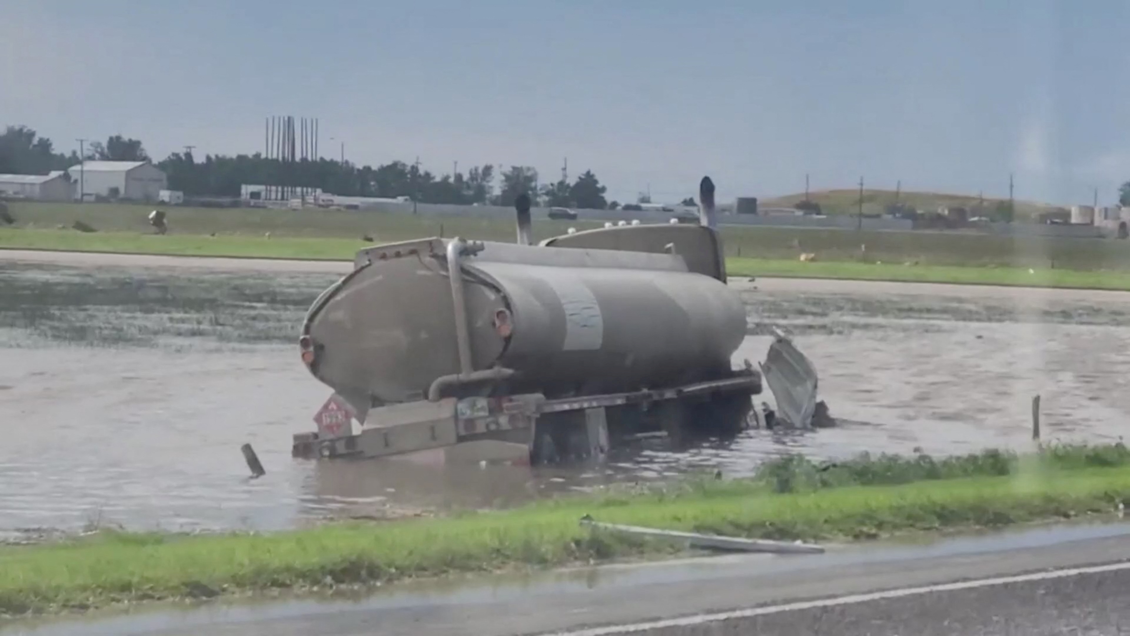 A tank truck gets partially submerge in water in Perryton as the town gets struck by a tornado, in Texas, U.S. June 15, 2023, in this screengrab obtained from a social media video. Sabrina Devers via TMX/via REUTERS