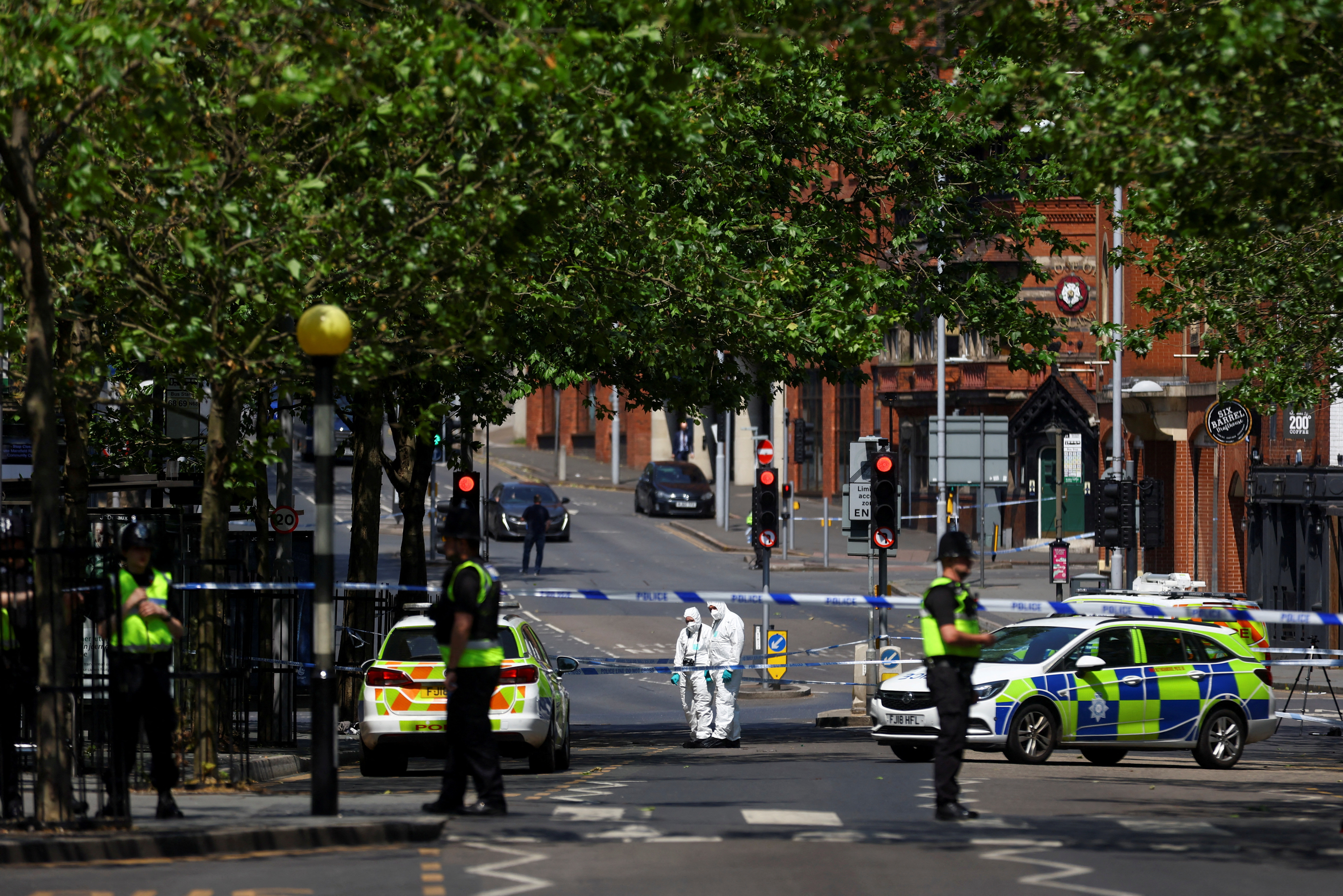 FILE PHOTO: Police forensics officers work at a site cordoned with police tape, following a major incident in Nottingham city centre, Nottingham, Britain, June 13, 2023. REUTERS/Carl Recine/File Photo
