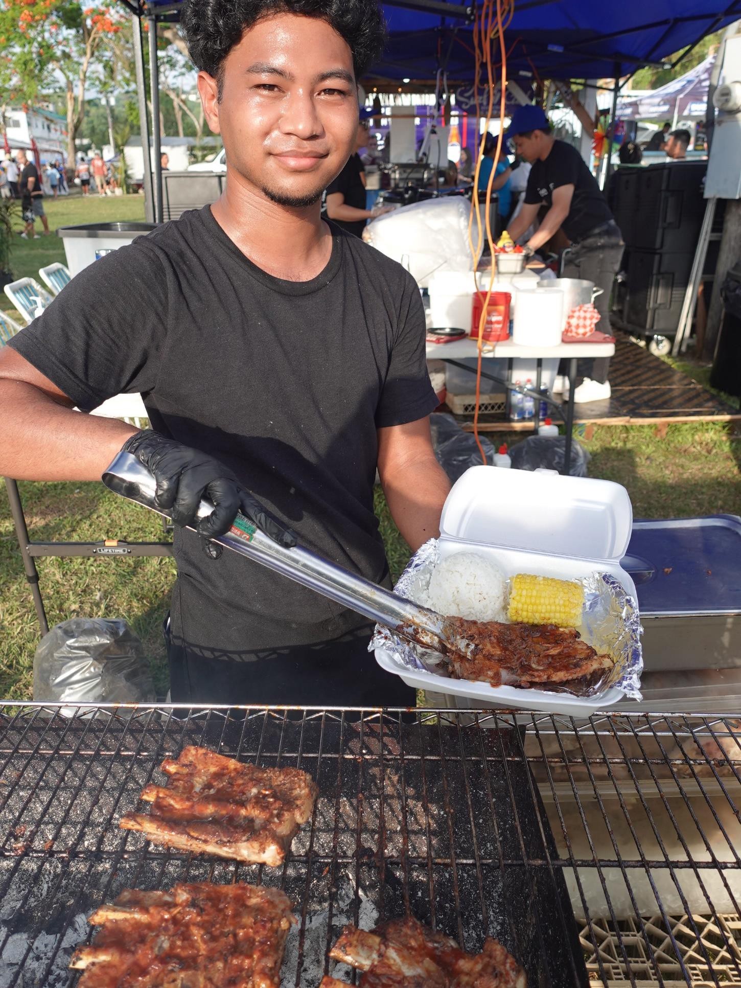 Surf Club Saipan serves a classic hot plate of rice, corn on the cob, and ribs at the 24th Annual Taste of the Marianas International Food Festival & Beer Garden on June 17, 2023, at Garapan Fishing Base, Saipan.  The festival is an annual signature event of the Marianas Visitors Authority and features food, drinks, live entertainment, and arts and crafts.