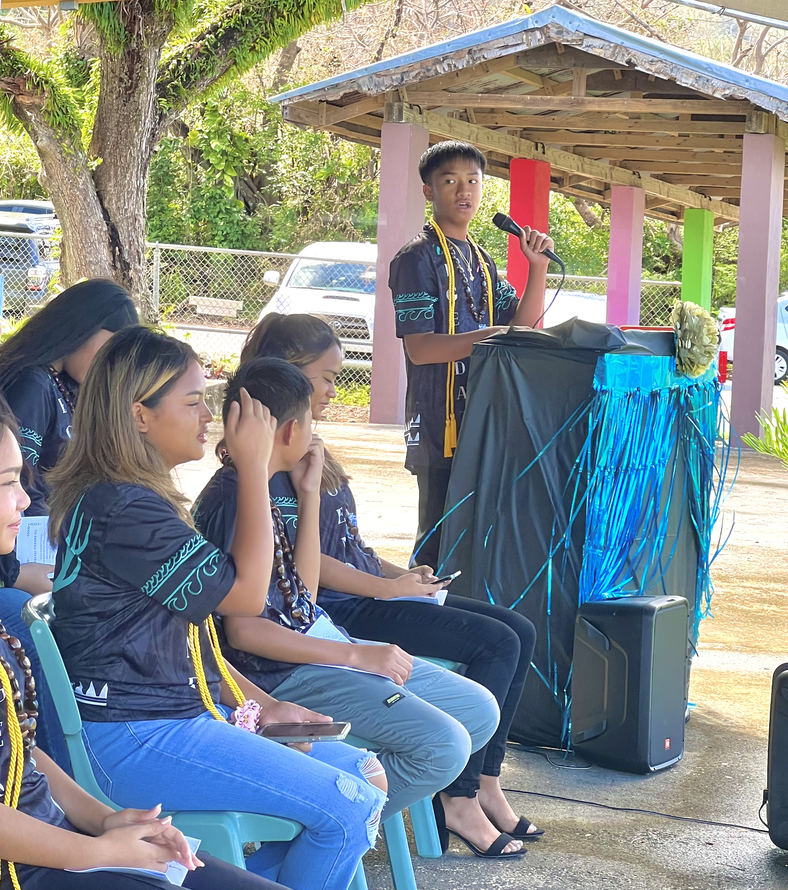 Class valedictorian Genaro Gonzales Mejia III delivers his address during the Rota Jr. High School promotion ceremony on June 2.