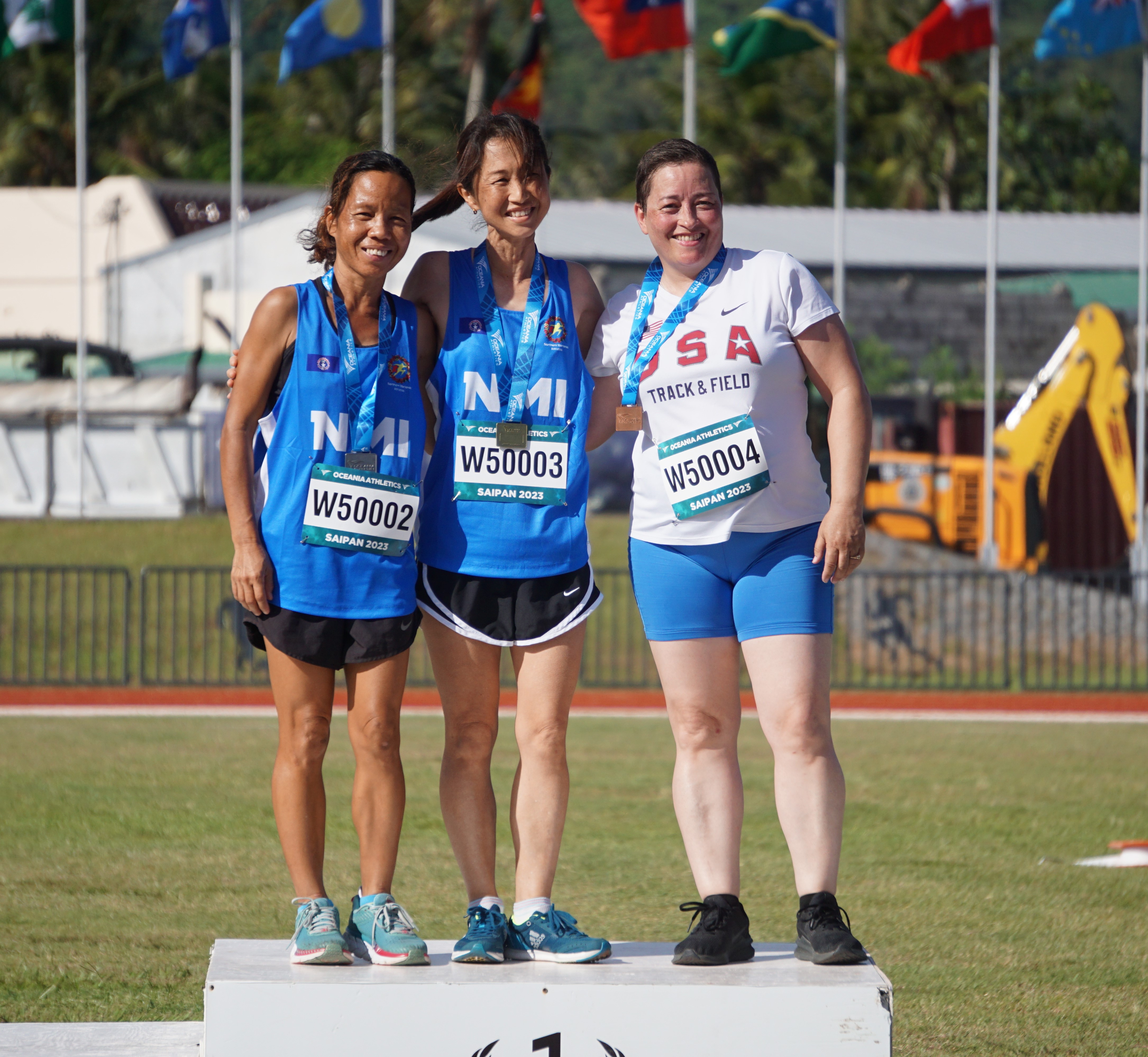 The NMI's Chiharu Sato, center, Jessica Ortizo, left, and Lainnie Price pose after receiving their medals in the Women's 60 Meters 50-54 age group of the Oceania Masters Championships Thursday at the Oleai Sports Complex Oval track and field.