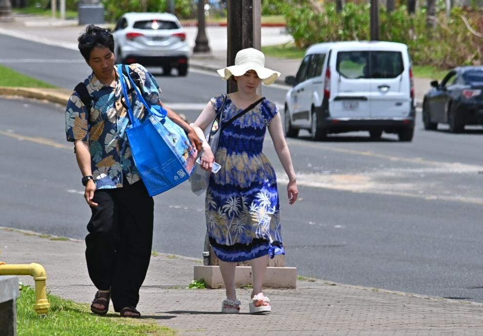 Tourists are seen walking down Pale San Vitores Road Wednesday, June 14, 2023, in Tumon. 